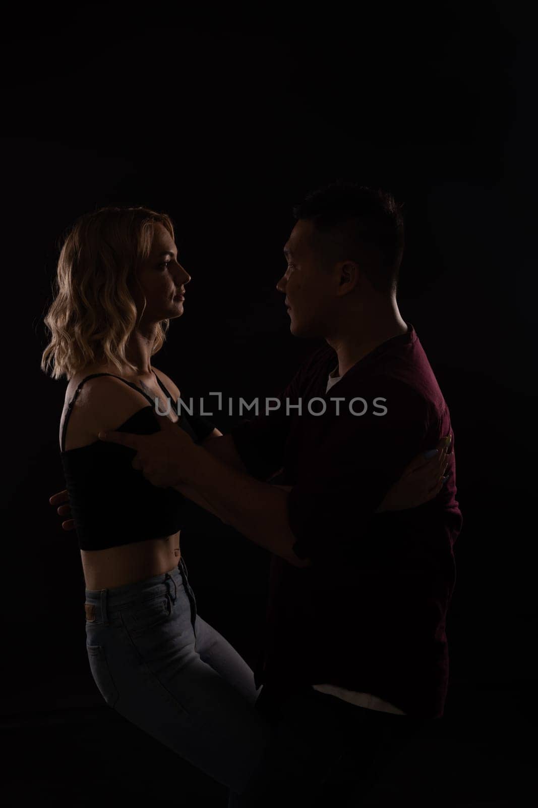 Man and woman dancers in dark
