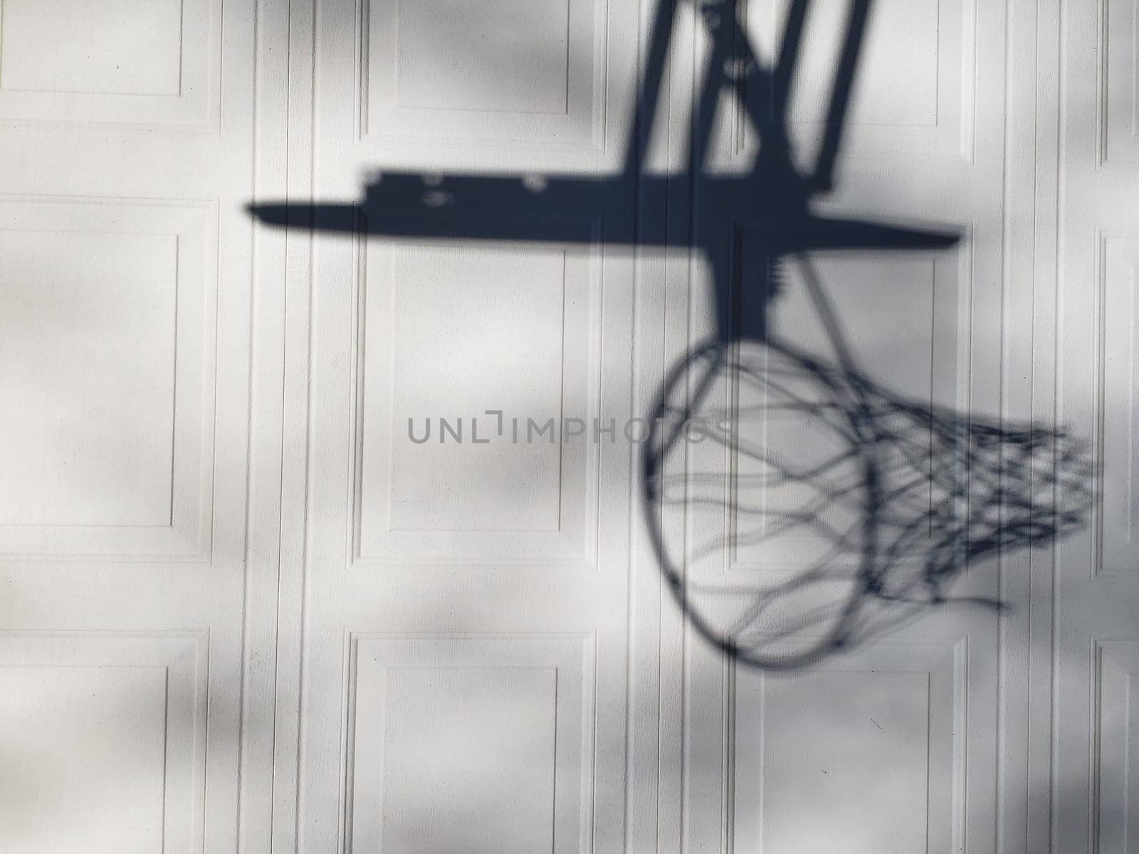 View of a Shadow of a Basketball Goal on Garage Door