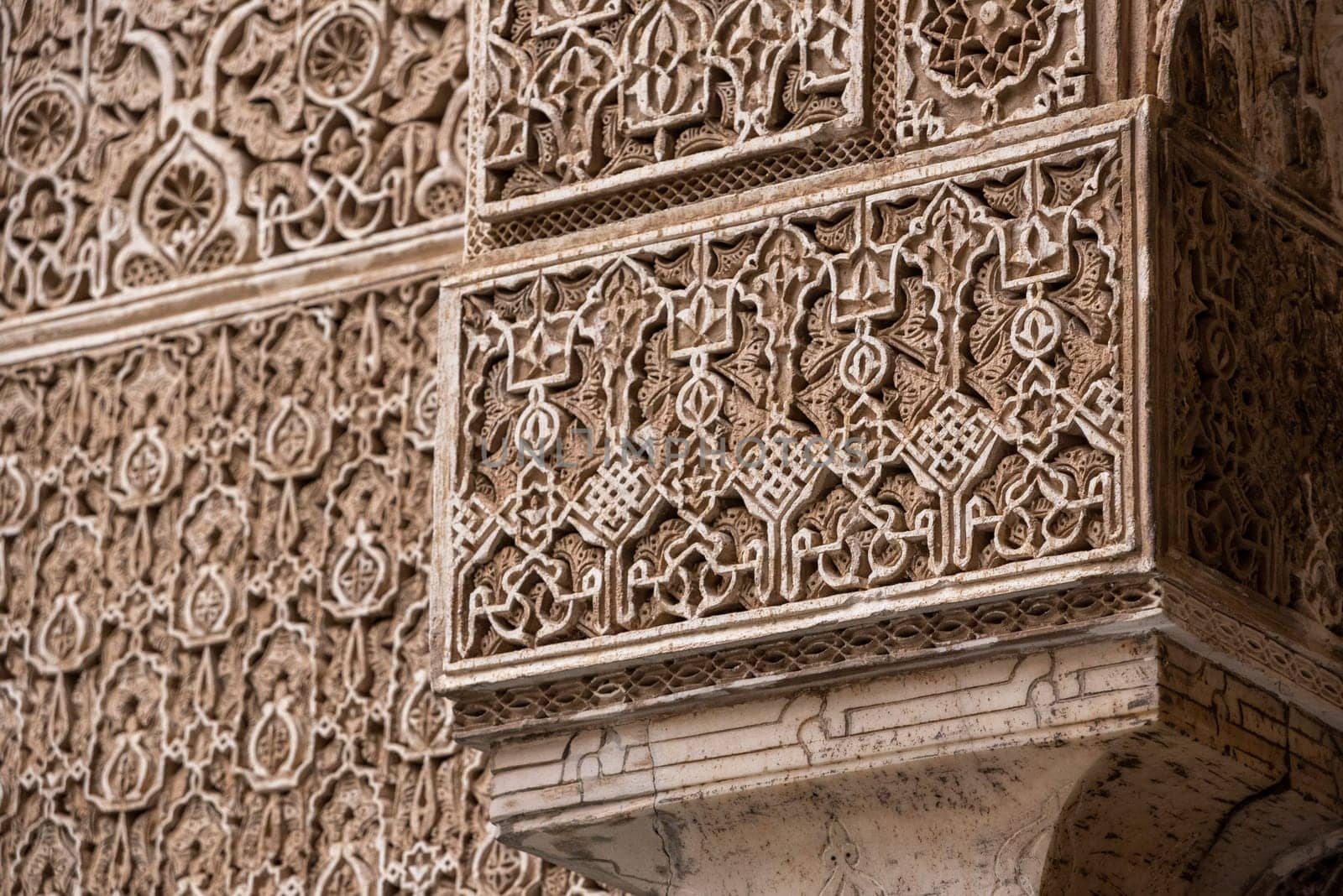 Fes, Morocco - April 04, 2023 - Rich decorated facade in the courtyard of the Medersa Attarine in Fes by imagoDens