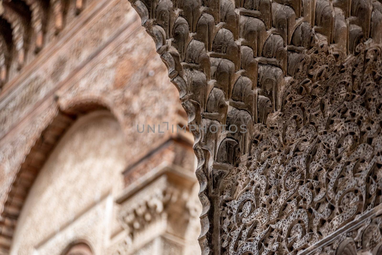 Rich decorated facade in the courtyard of a traditional madrasa, Morocco