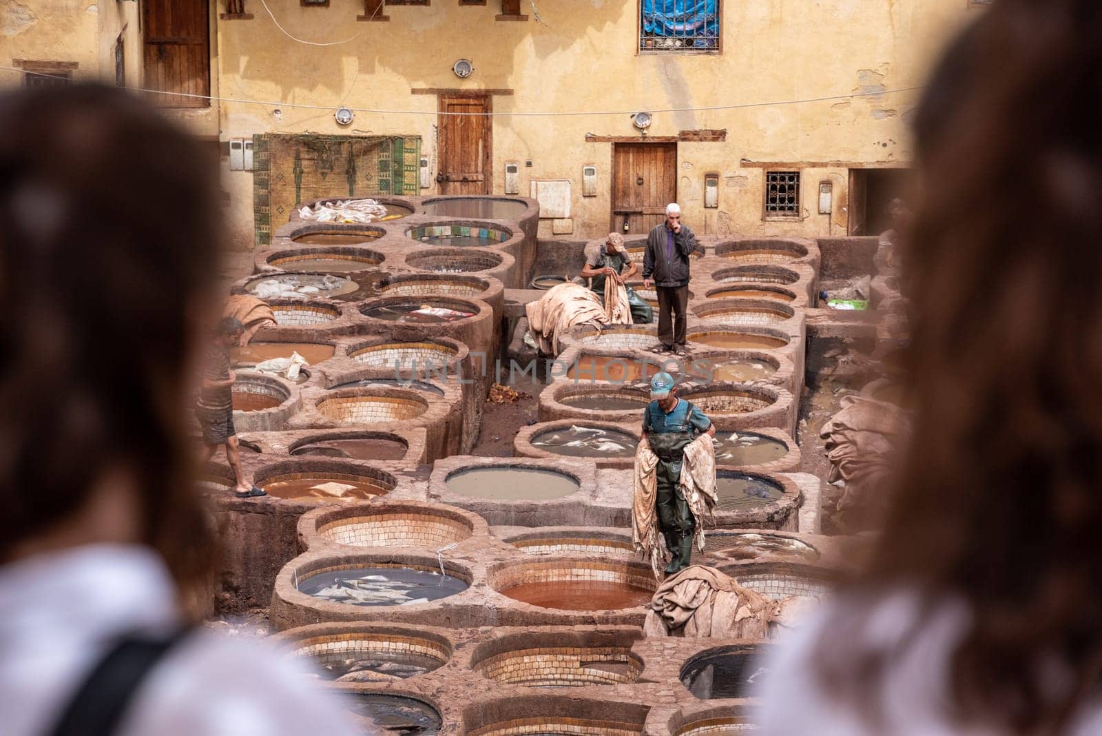 FES, MOROCCO - ARIL 10, 2023 - Famous tannery in the medina of Fes, where leather is being processed for generations by imagoDens