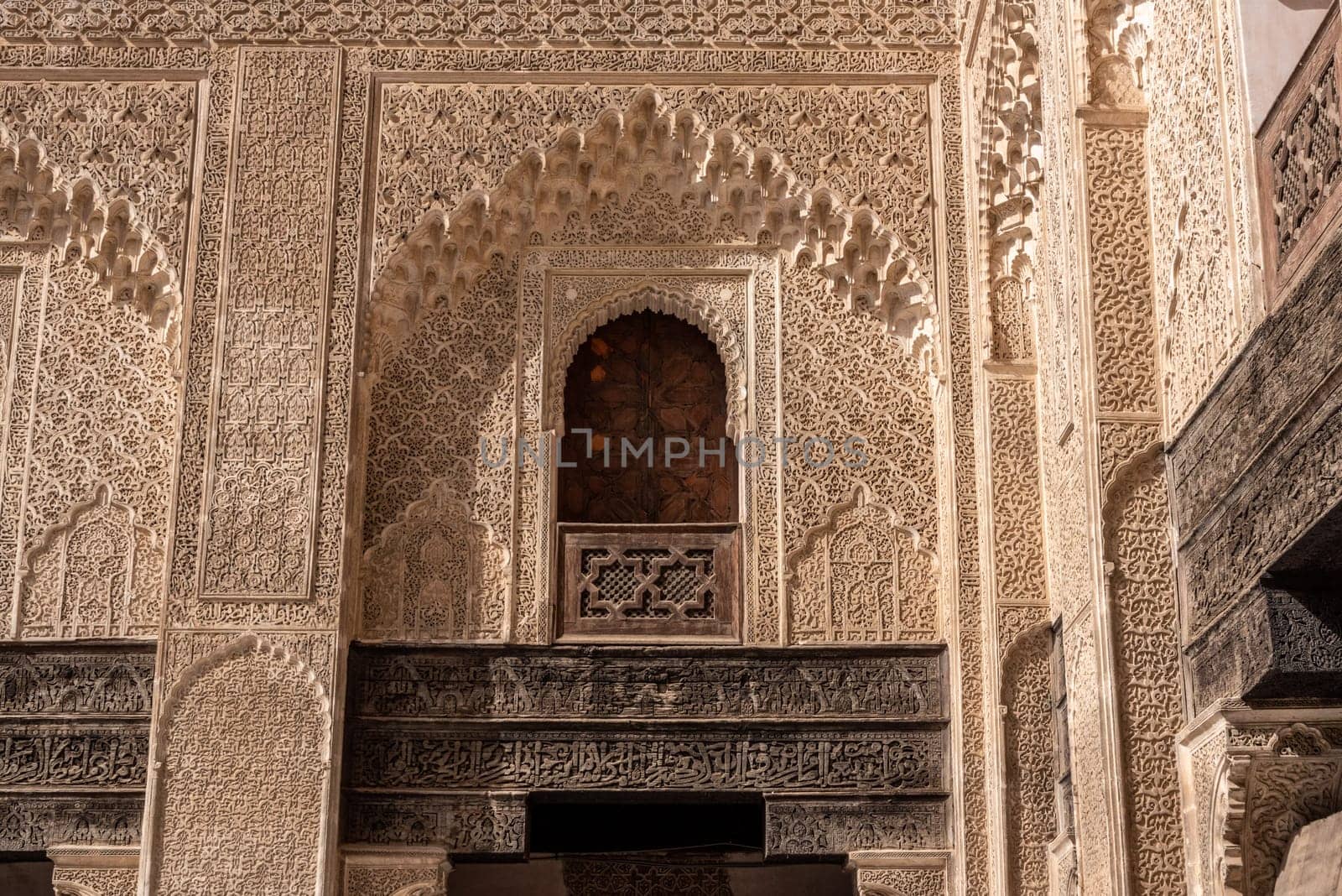 Fes, Morocco - April 05, 2023 - Traditional oriental facade at the courtyard of madrasa Bou Inaniya in the medina of Fes by imagoDens