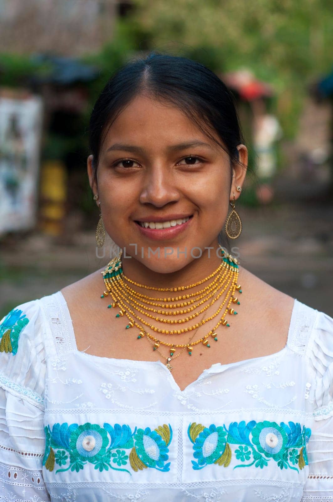 closeup of a very smiling and happy indigenous girl looking at a camera in her village. High quality photo