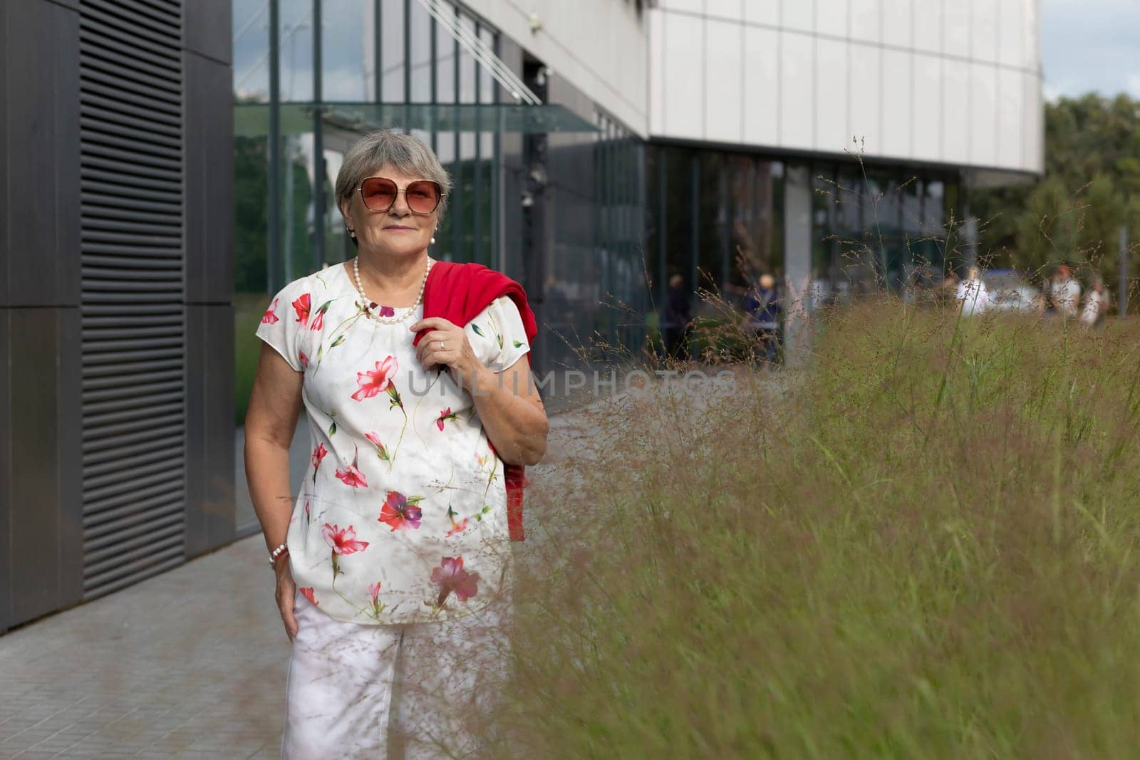 Portrait Real Beautiful Senior Elderly Woman With Gray Silver Hair in City Near Shopping Mall At Summer Day. Beautiful Retired Mature Lady With Sun Glasses. Authentic Lifestyle Horizontal, Copy Space