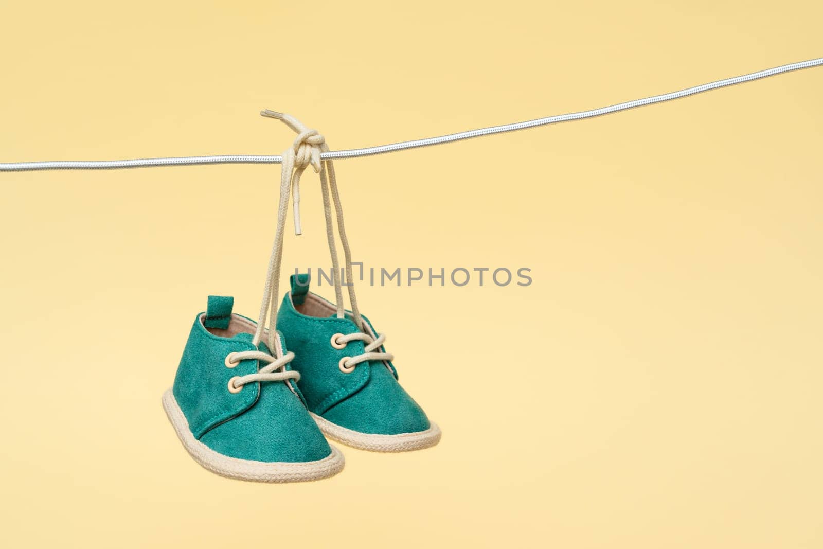 As baby shoes gently sway on the clothesline, they become a heartwarming symbol of a newborn's