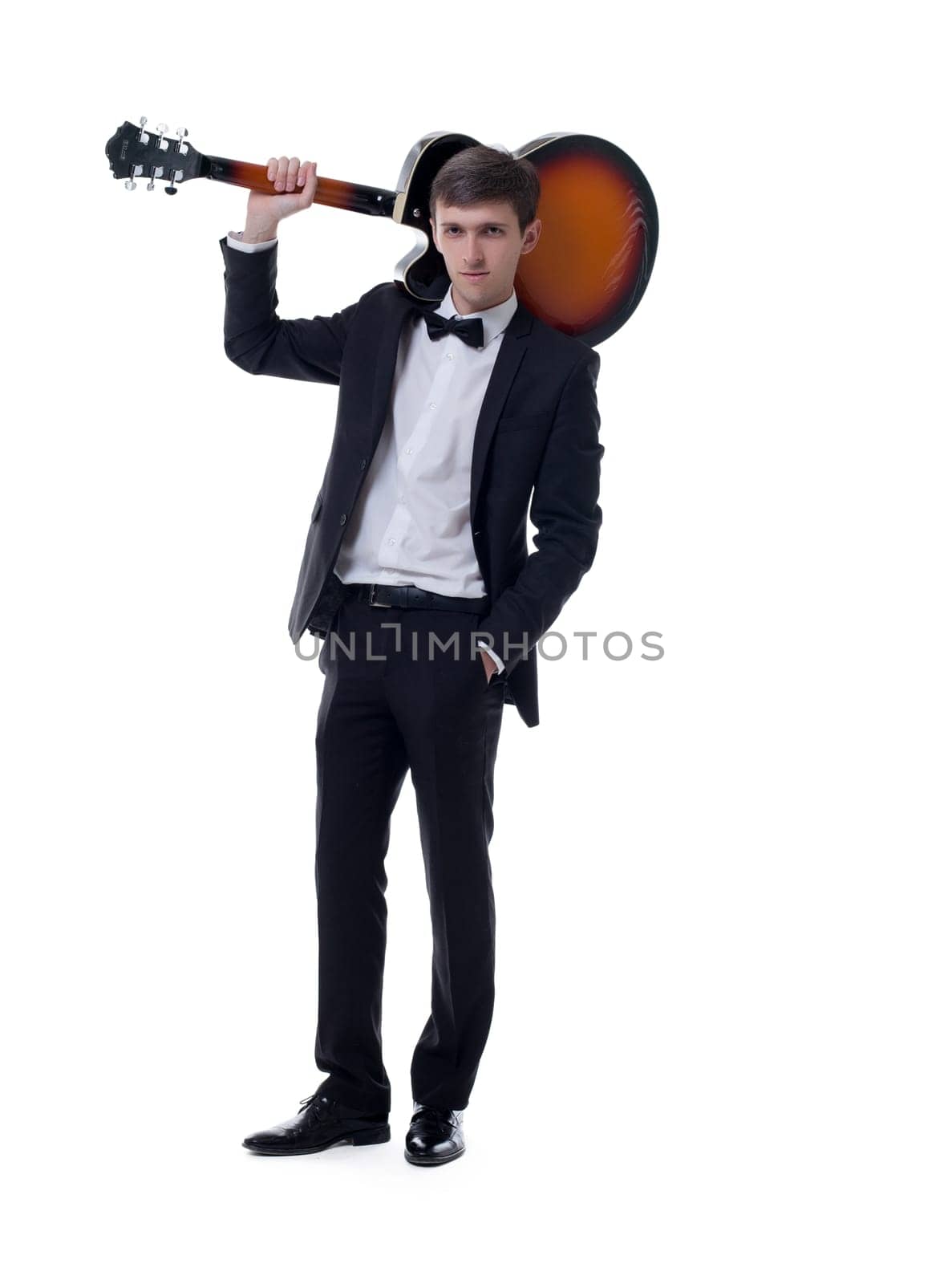 Elegant musician posing with guitar, isolated on white