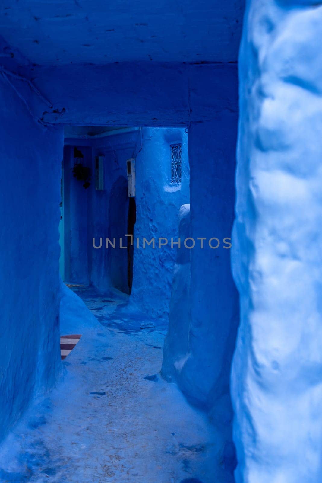 Vibrant blue colored wooden door in downtown Chefchaouen, Morocco