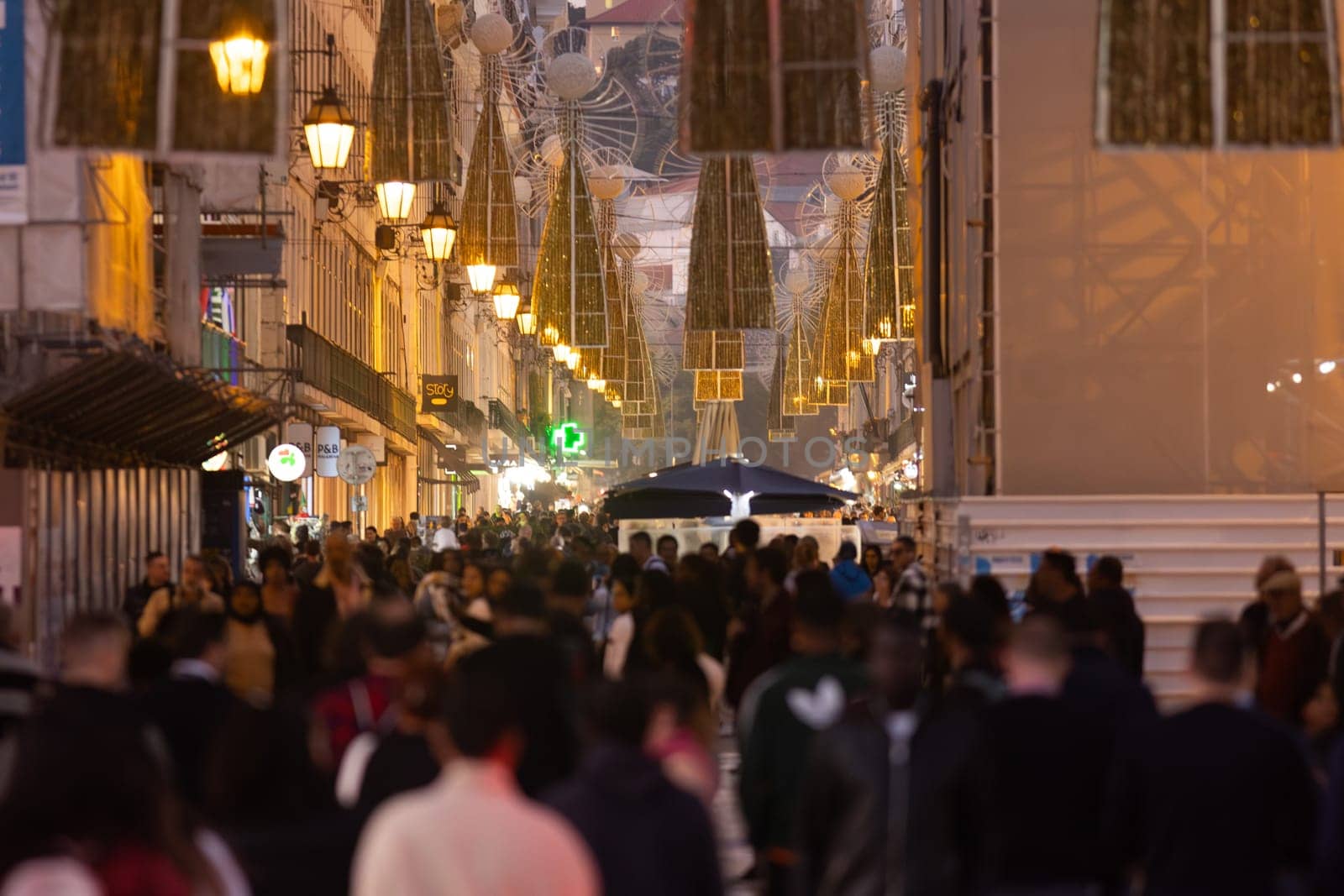 A crowd of people walking down a street Rua Agusta - telephoto