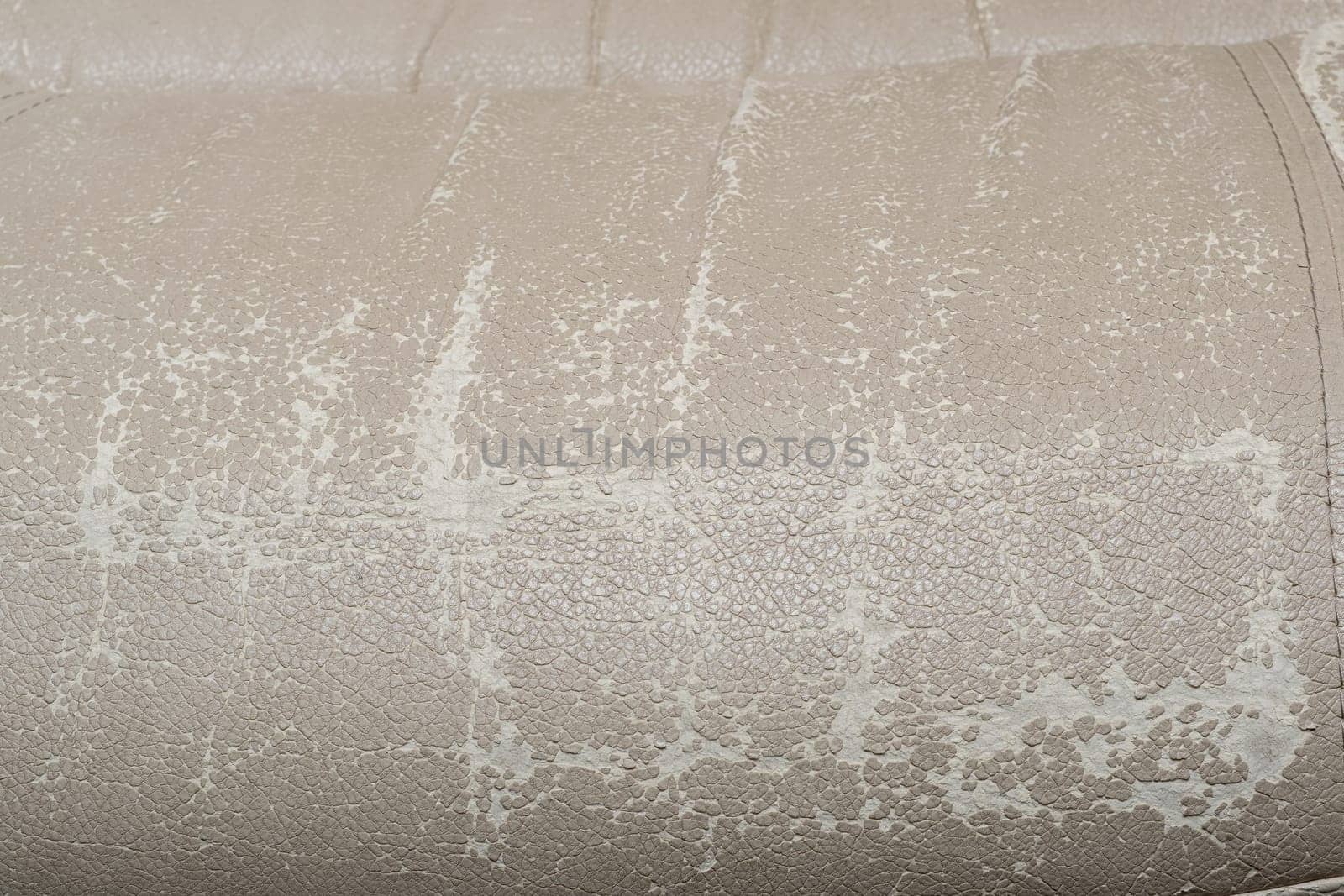 Defects on a white leather sofa. Damaged to leather furniture. by AnatoliiFoto