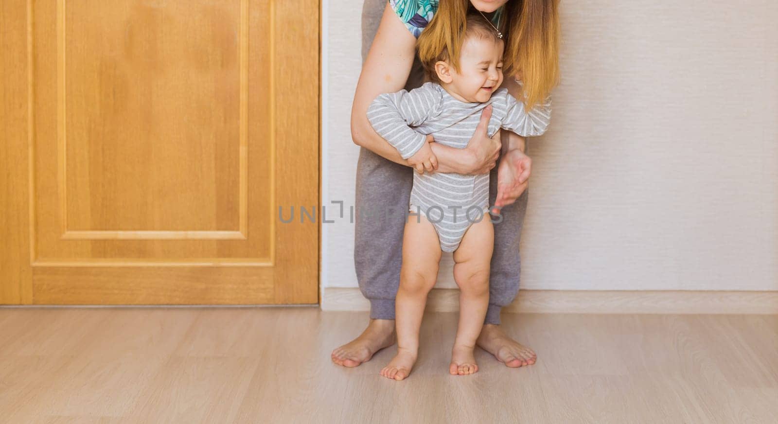 Beautiful smiling cute baby boy with his mother