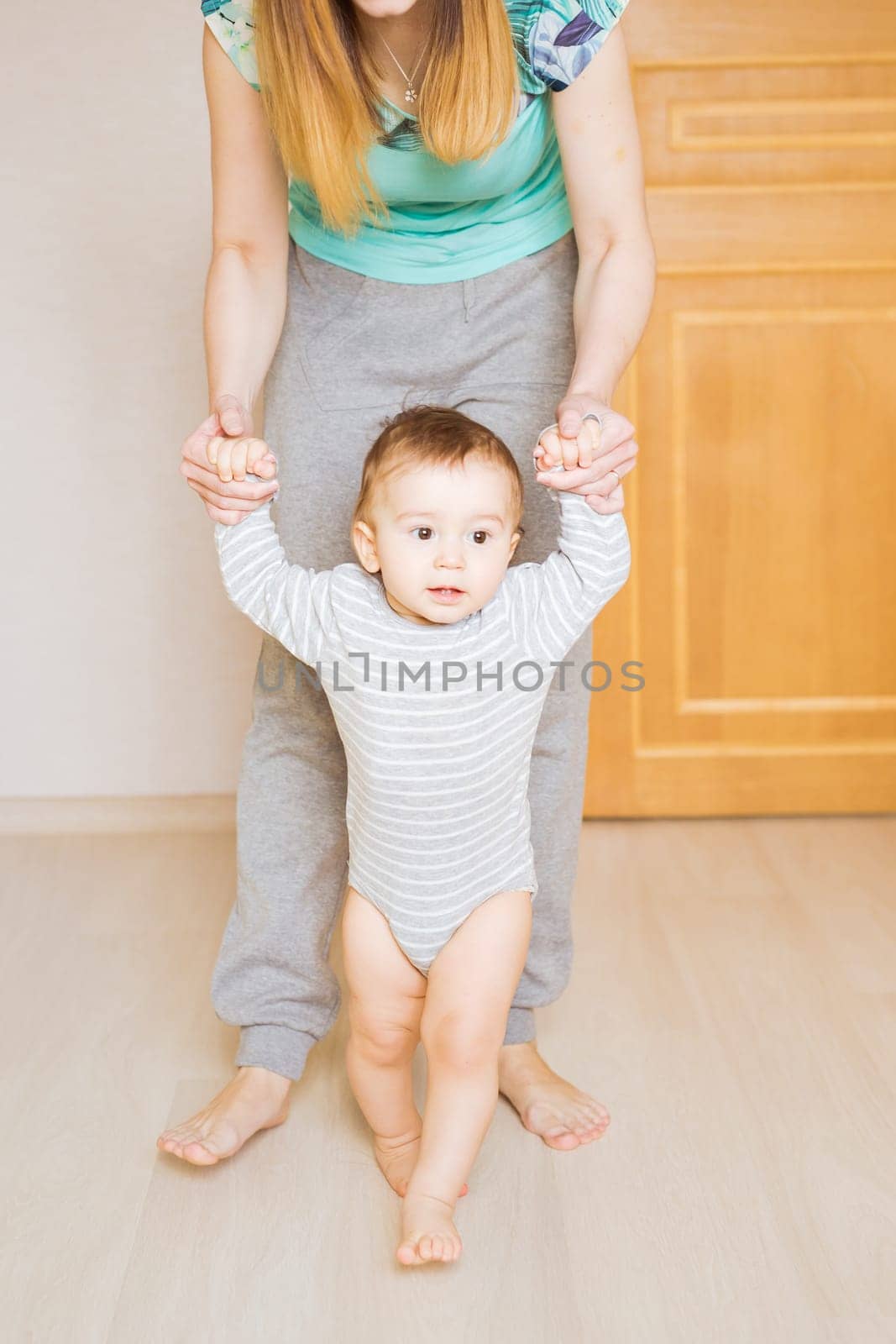 little boy first steps with the help of mother by Satura86