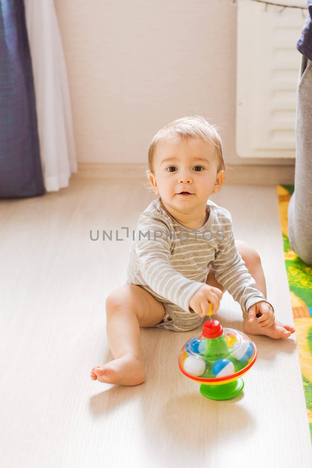 Little cute baby boy plays in his room