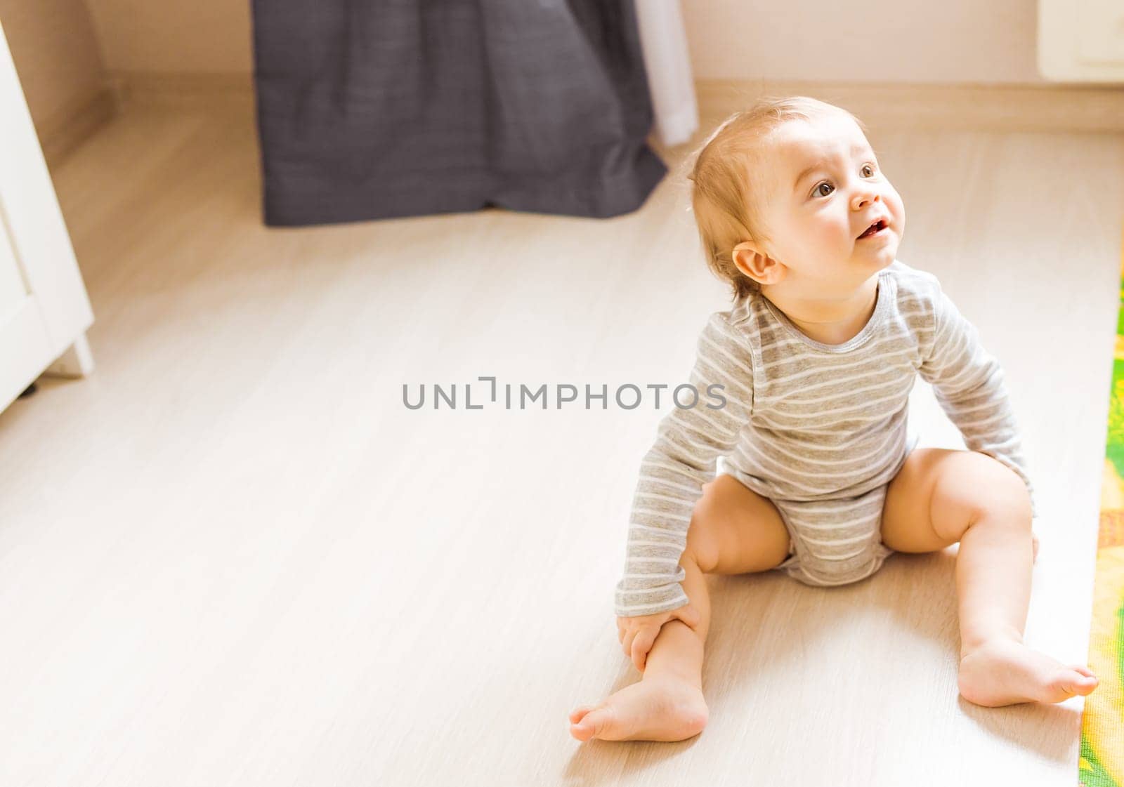 Little cute baby boy plays in his room