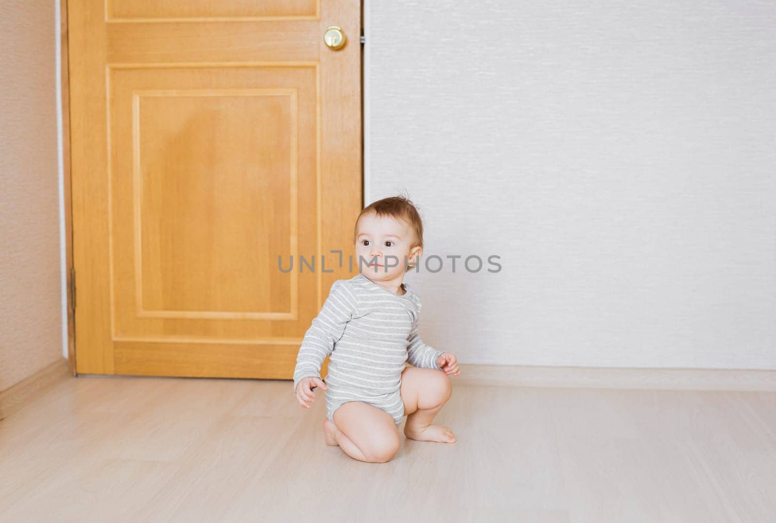 Little cute baby boy plays in his room