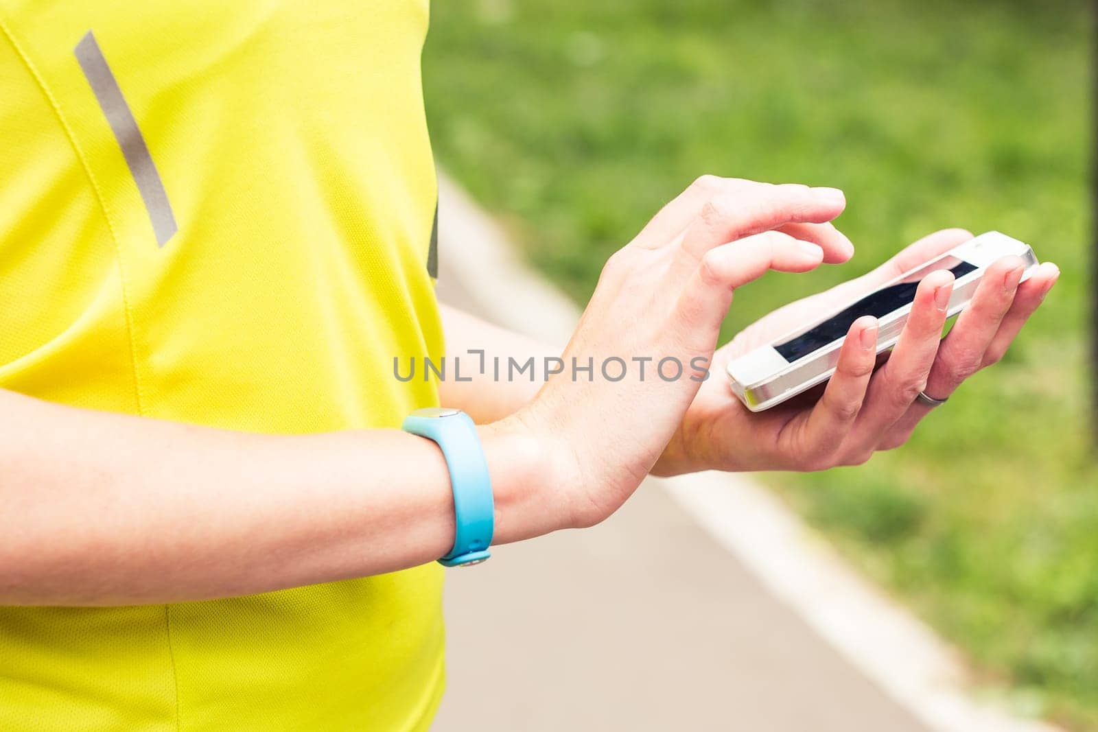 Woman checking fitness and health tracking wearable device.