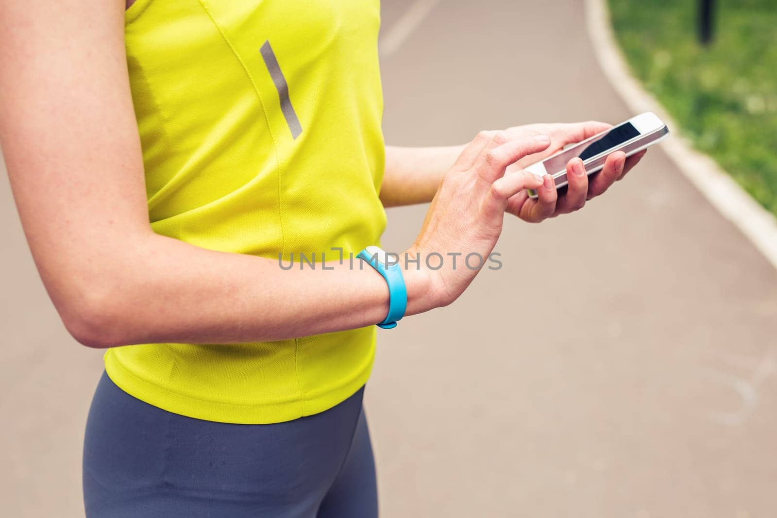 Woman checking fitness and health tracking wearable device.