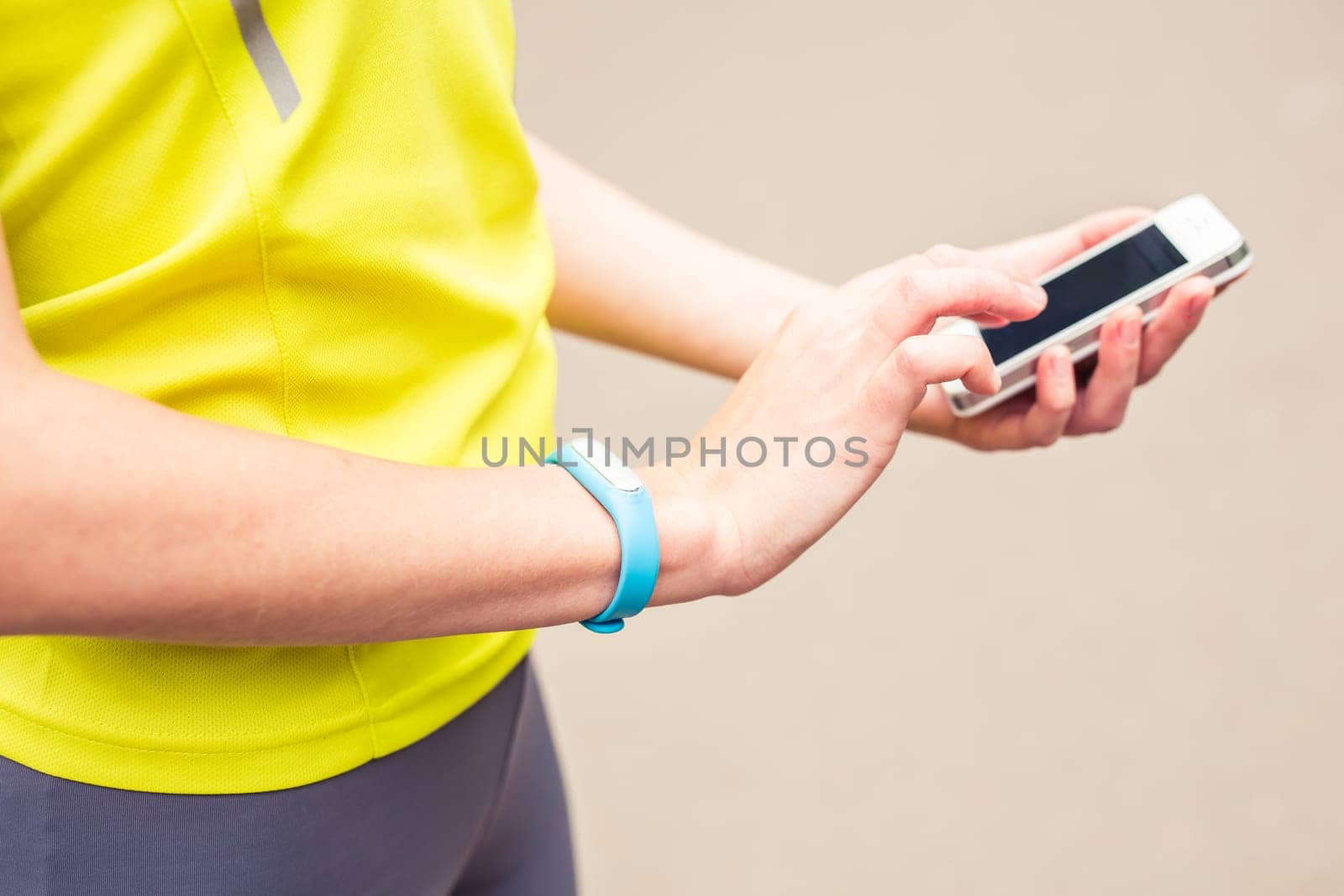 Hand wearing a fitness tracking armband indoors