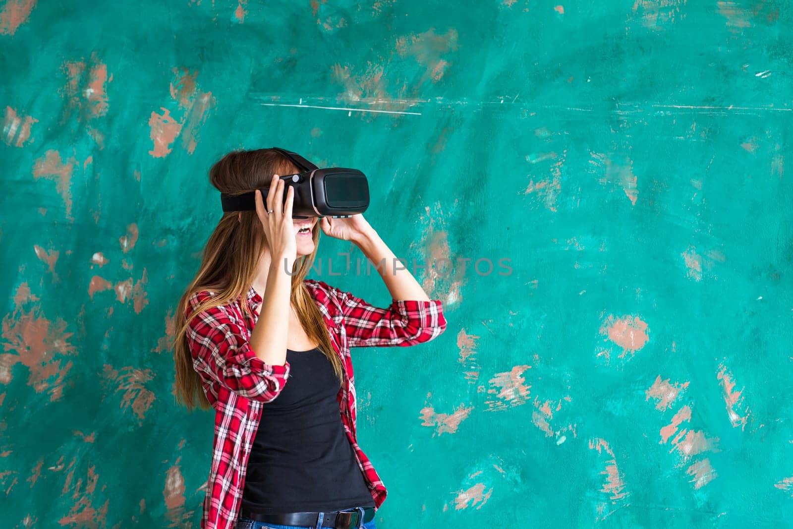 Woman in virtual reality headset enjoying her experience by Satura86