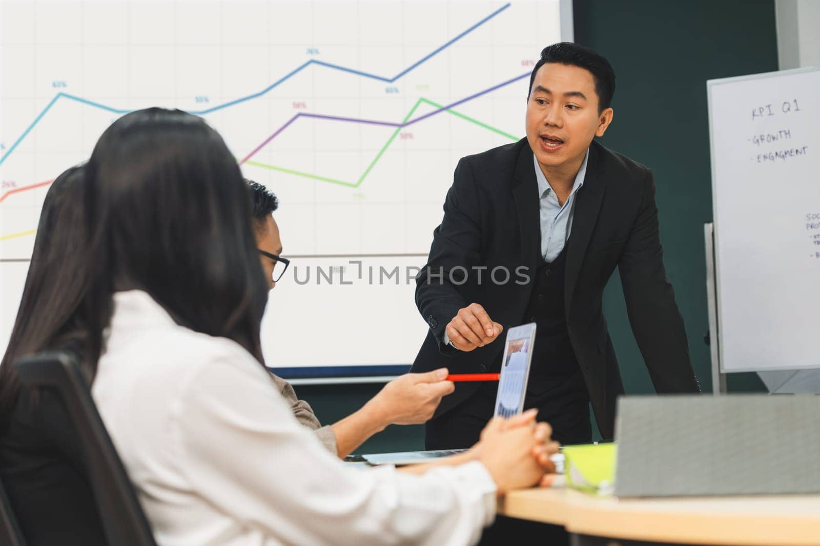 Successful businessman presenting his financial plan and data analyst with confident. group of executive editor focusing on his performance intentionally. Office Conference room meeting. Intellectual.