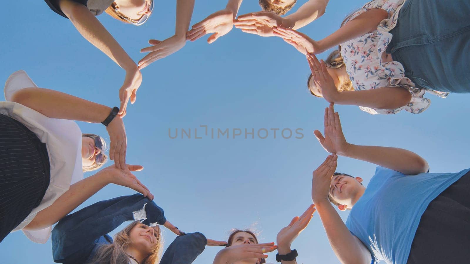 School friends make a big circle with their hands