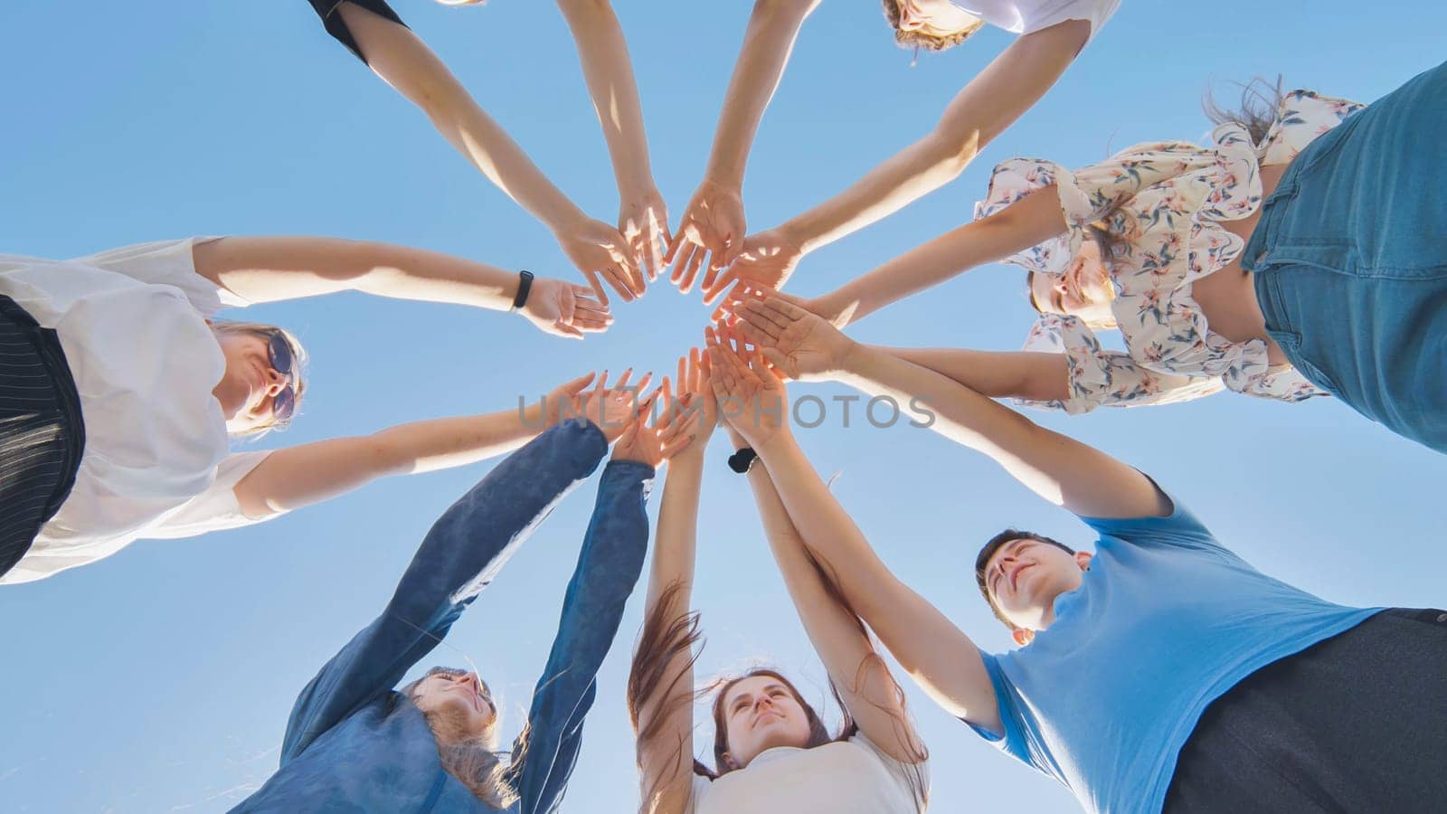 Friends putting their hands together in a sign of unity and teamwork. Just the hands