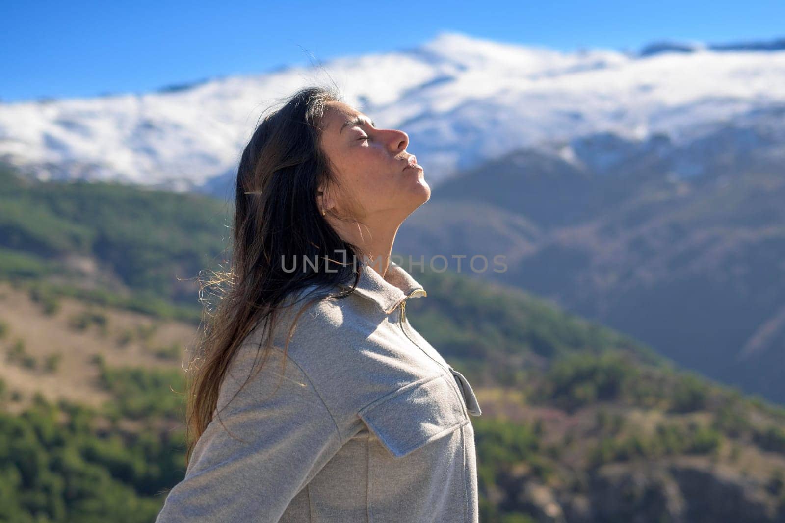 profile portrait of latina woman on snowy mountain background by carlosviv