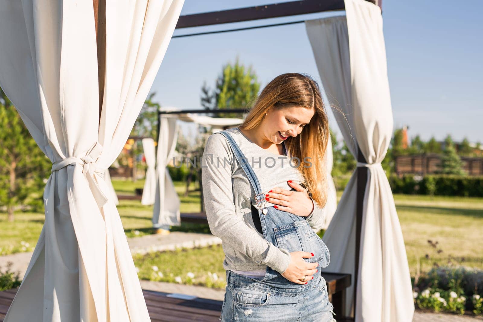 young happy pregnant woman relaxing and enjoying life in autumn nature.