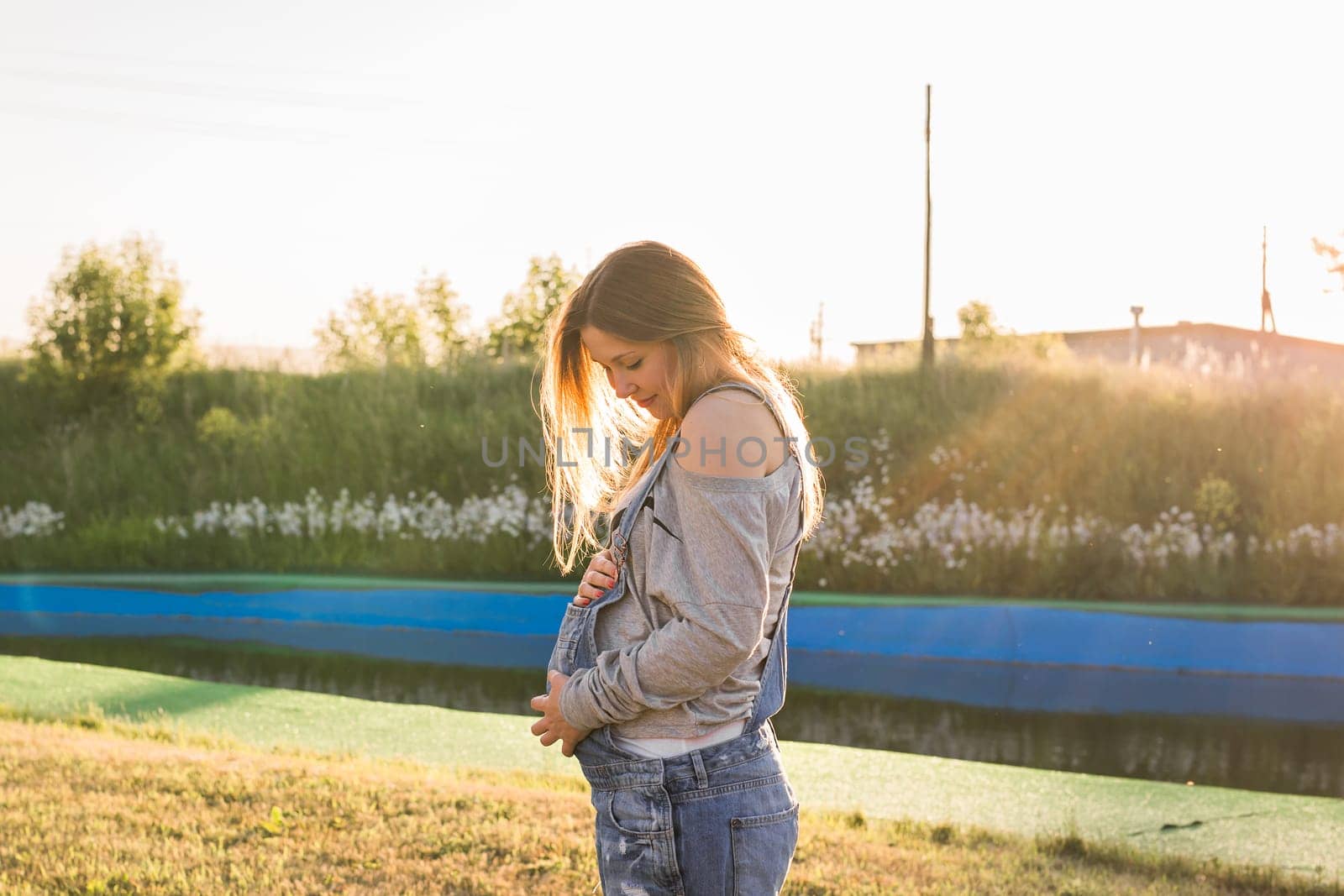 young happy pregnant woman relaxing and enjoying life in autumn nature.