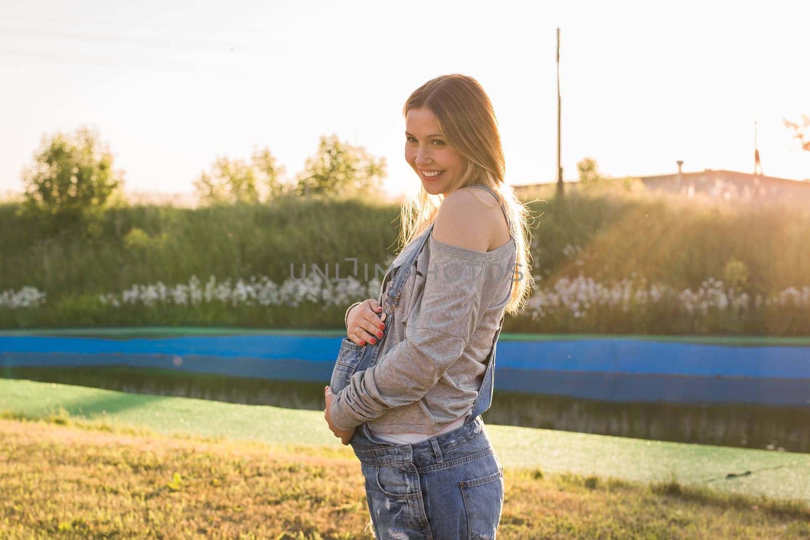 young happy pregnant woman relaxing and enjoying life in autumn nature.