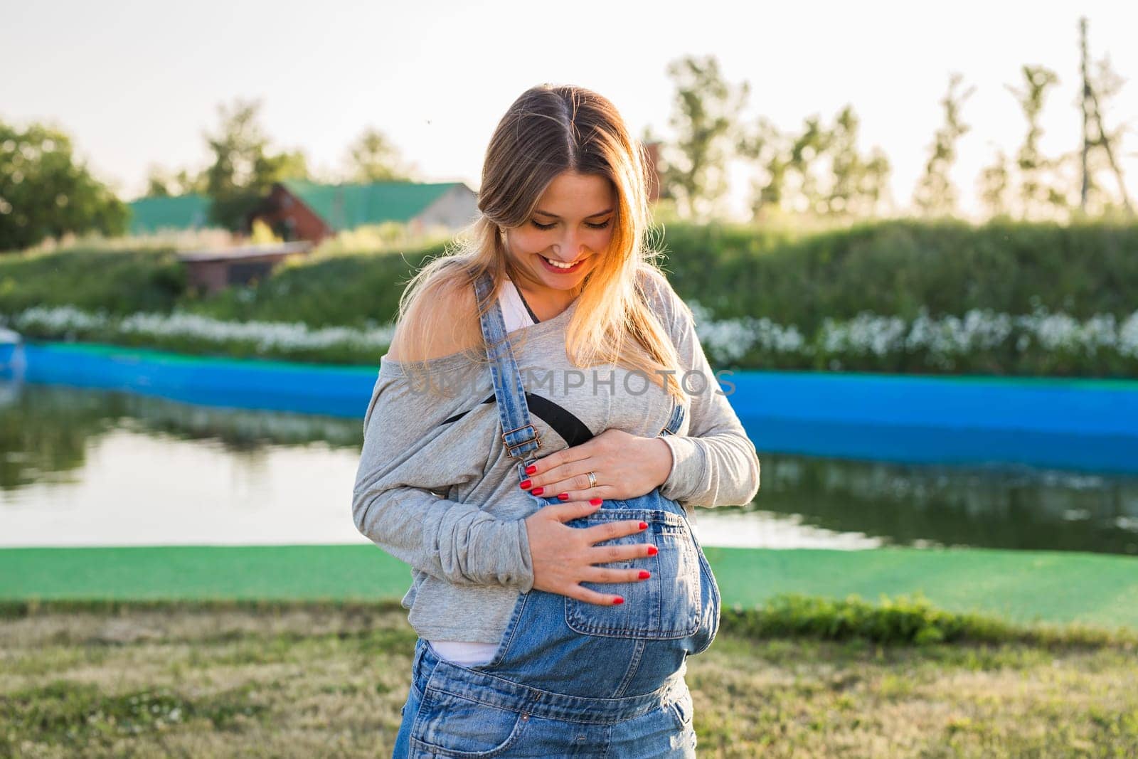 young happy pregnant woman relaxing and enjoying life in autumn nature by Satura86