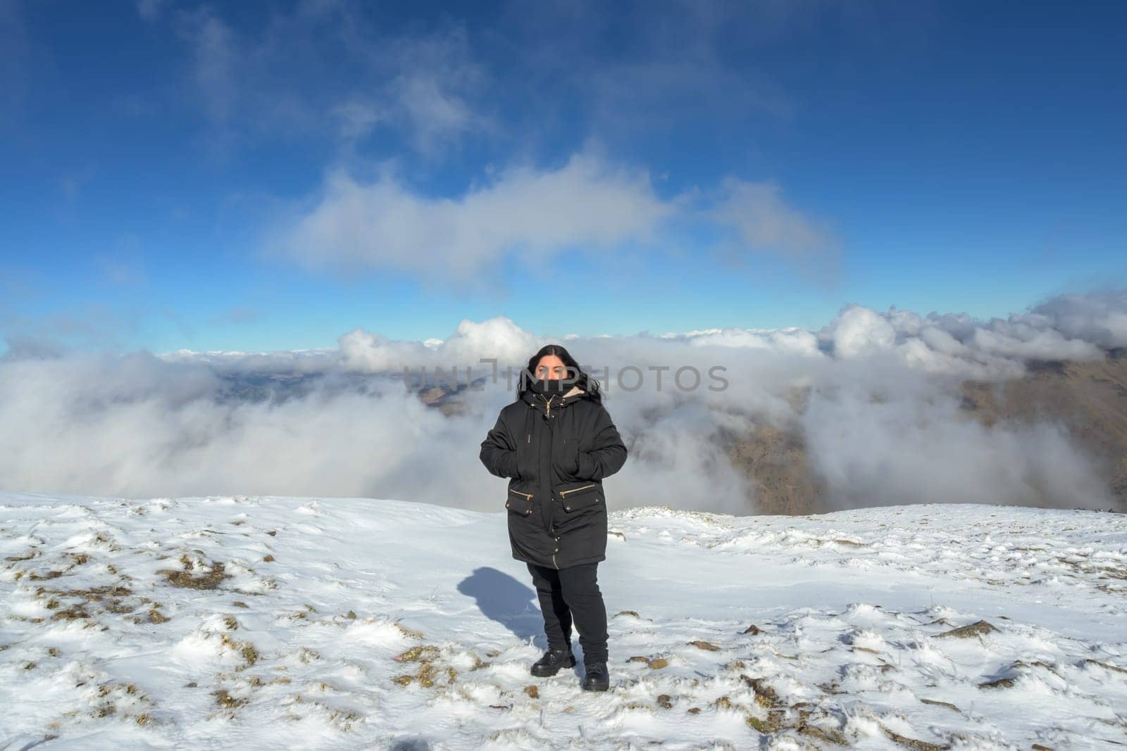 portrait young latina woman in the snow,