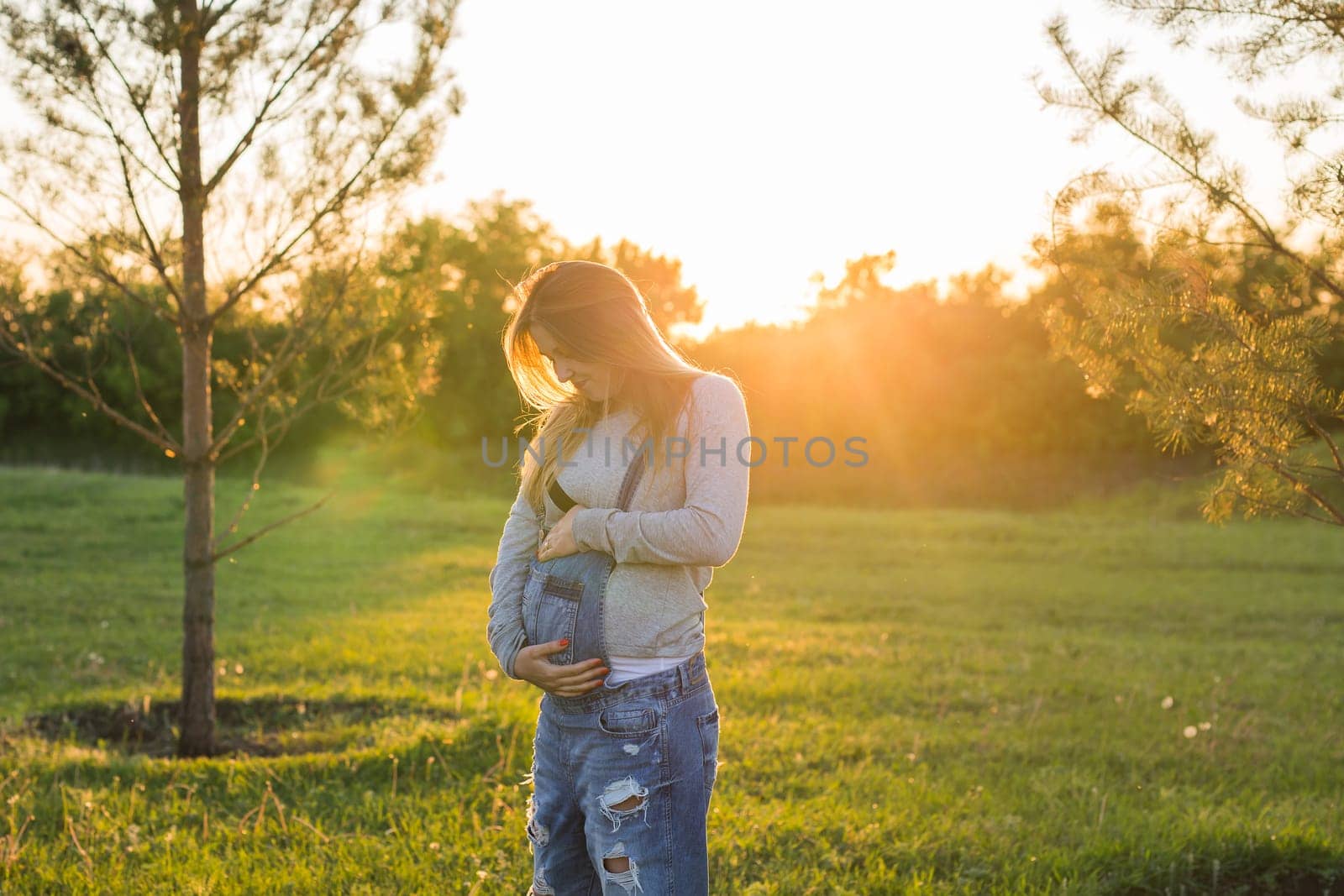 young happy pregnant woman relaxing and enjoying life in autumn nature by Satura86