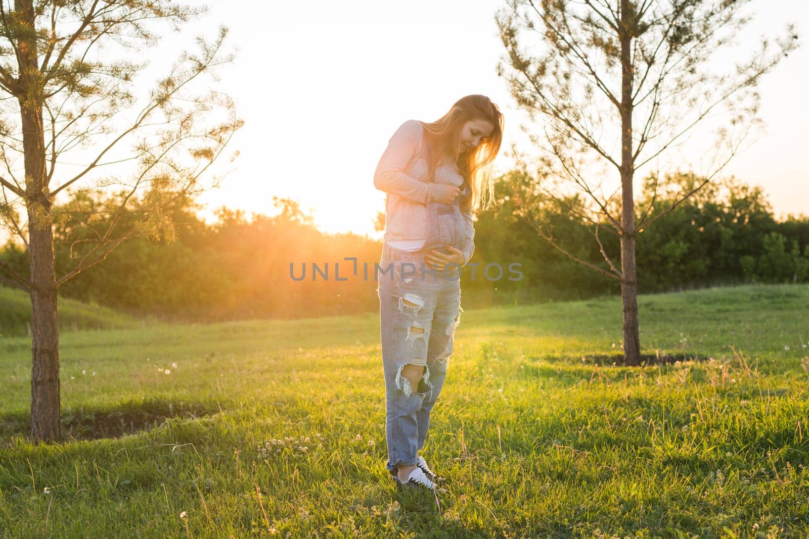 young happy pregnant woman relaxing and enjoying life in autumn nature.