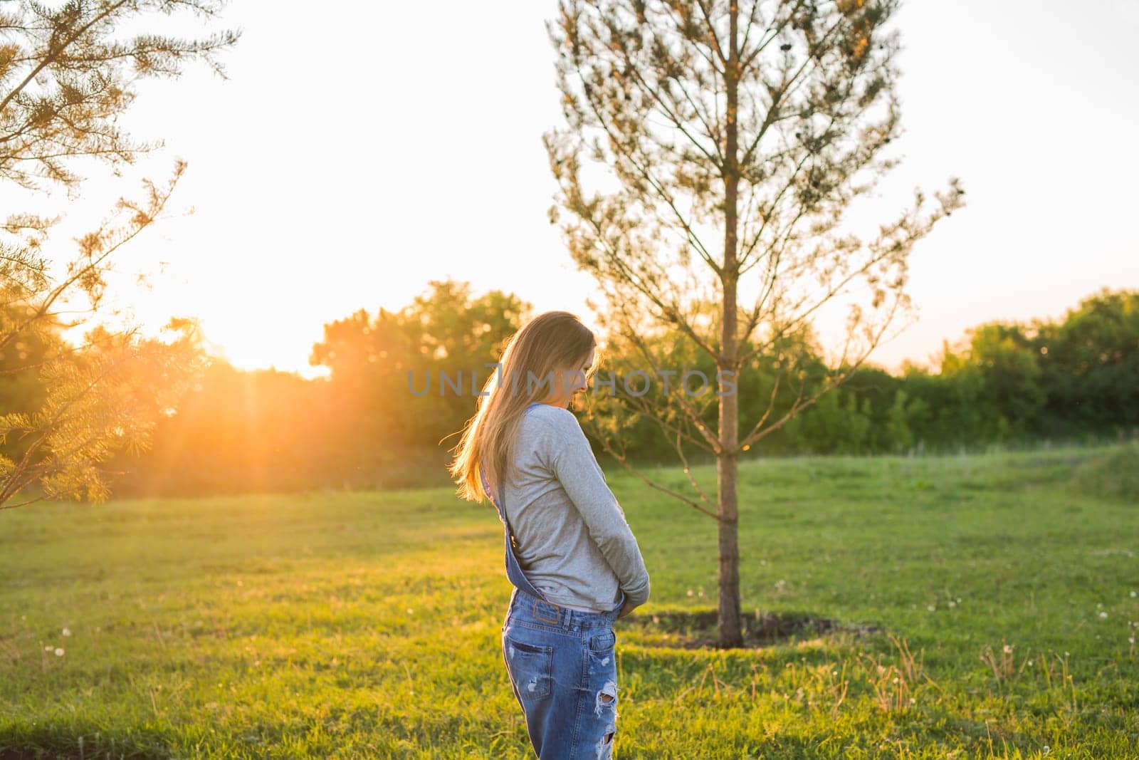 young happy pregnant woman relaxing and enjoying life in autumn nature.