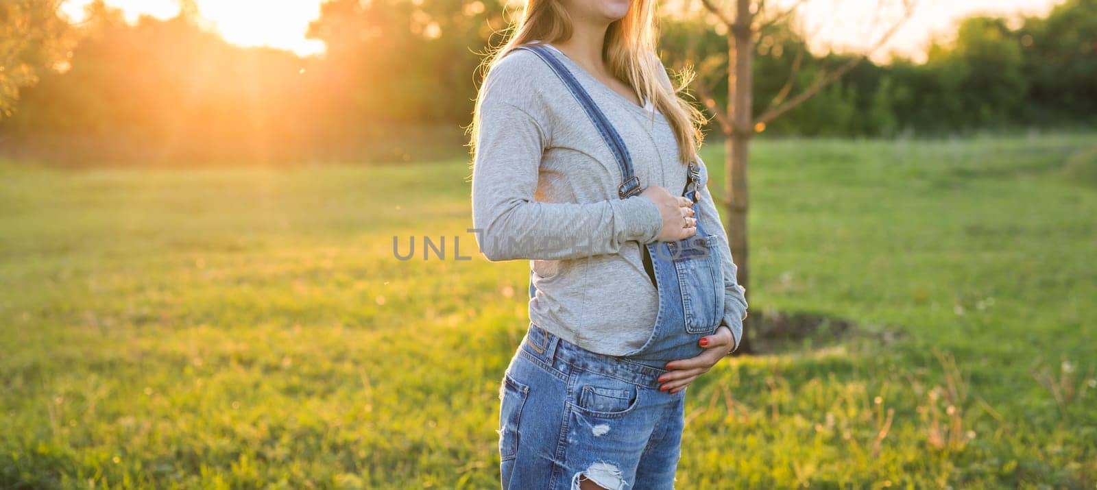 young happy pregnant woman relaxing and enjoying life in autumn nature.