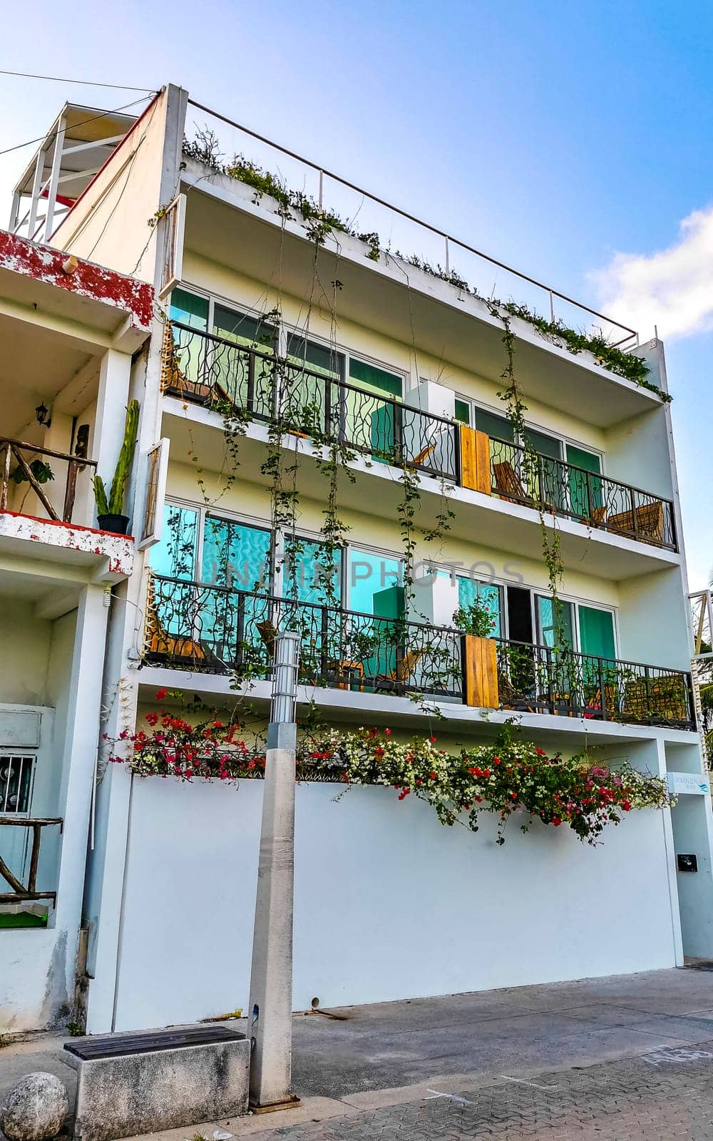 Playa del Carmen Quintana Roo Mexico 10. April 2021 Modern buildings and architecture hotels resorts and apartments in tropical paradise with palm trees in Playa del Carmen Quintana Roo Mexico.