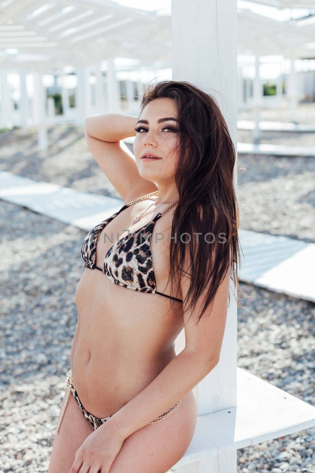 woman in swimsuit on the beach vacation resort by Simakov