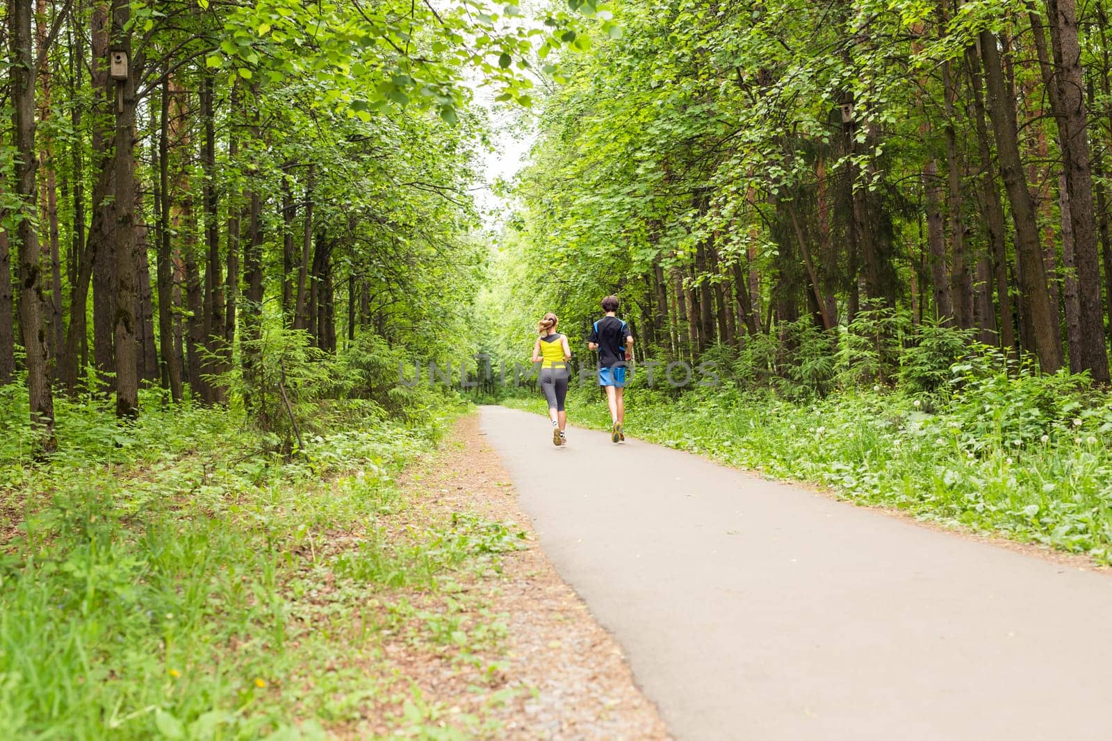 fitness, sport, friendship and lifestyle concept - smiling couple running outdoors. by Satura86