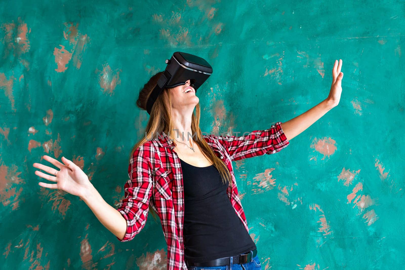 Smile happy woman getting experience using VR-headset glasses of virtual reality much gesticulating hands by Satura86