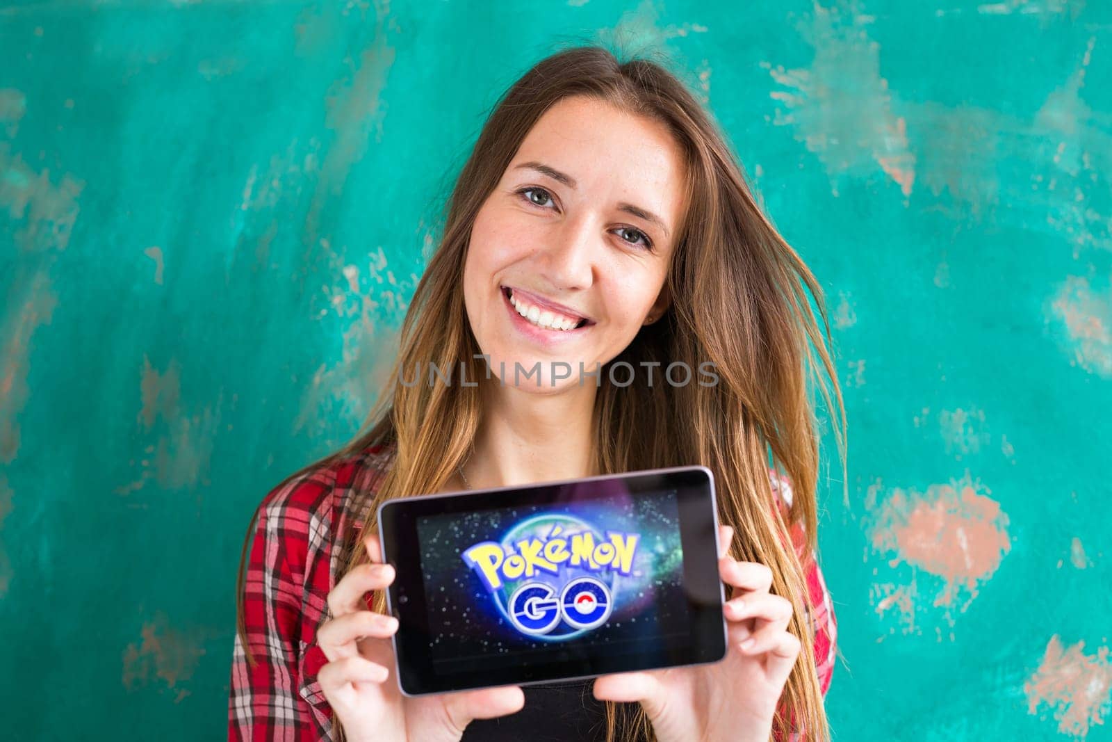 Ufa, Russia. - July 29: Woman show the tablet with Pokemon Go logo