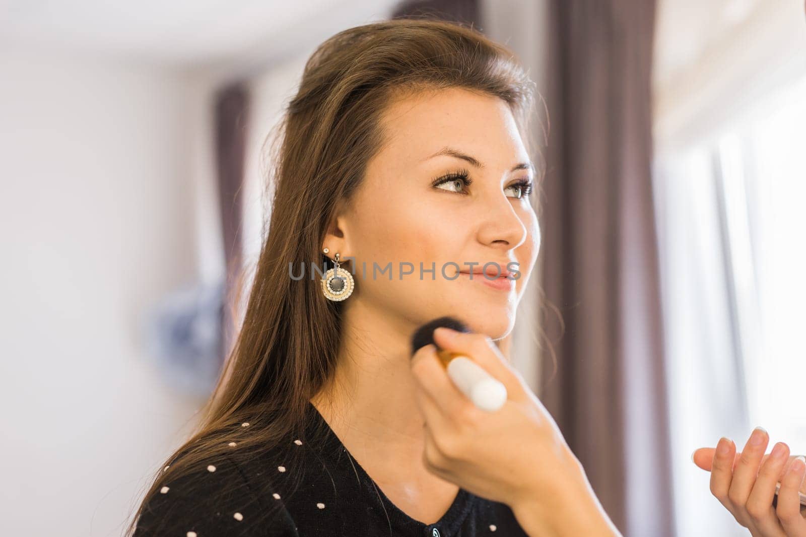 Closeup of a makeup artist applying makeup