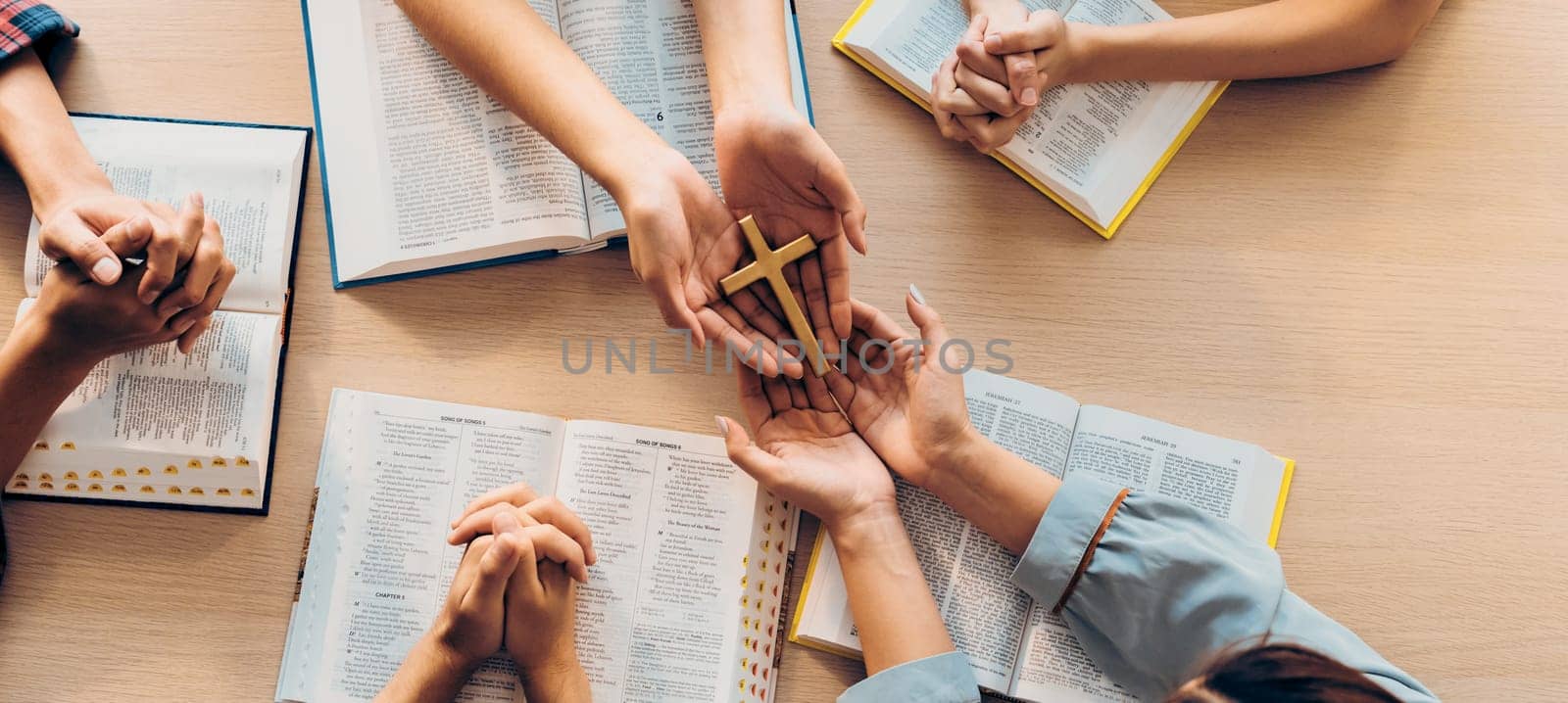 Close-up women prayer deliver holy bible book to believer group. Burgeoning. by biancoblue