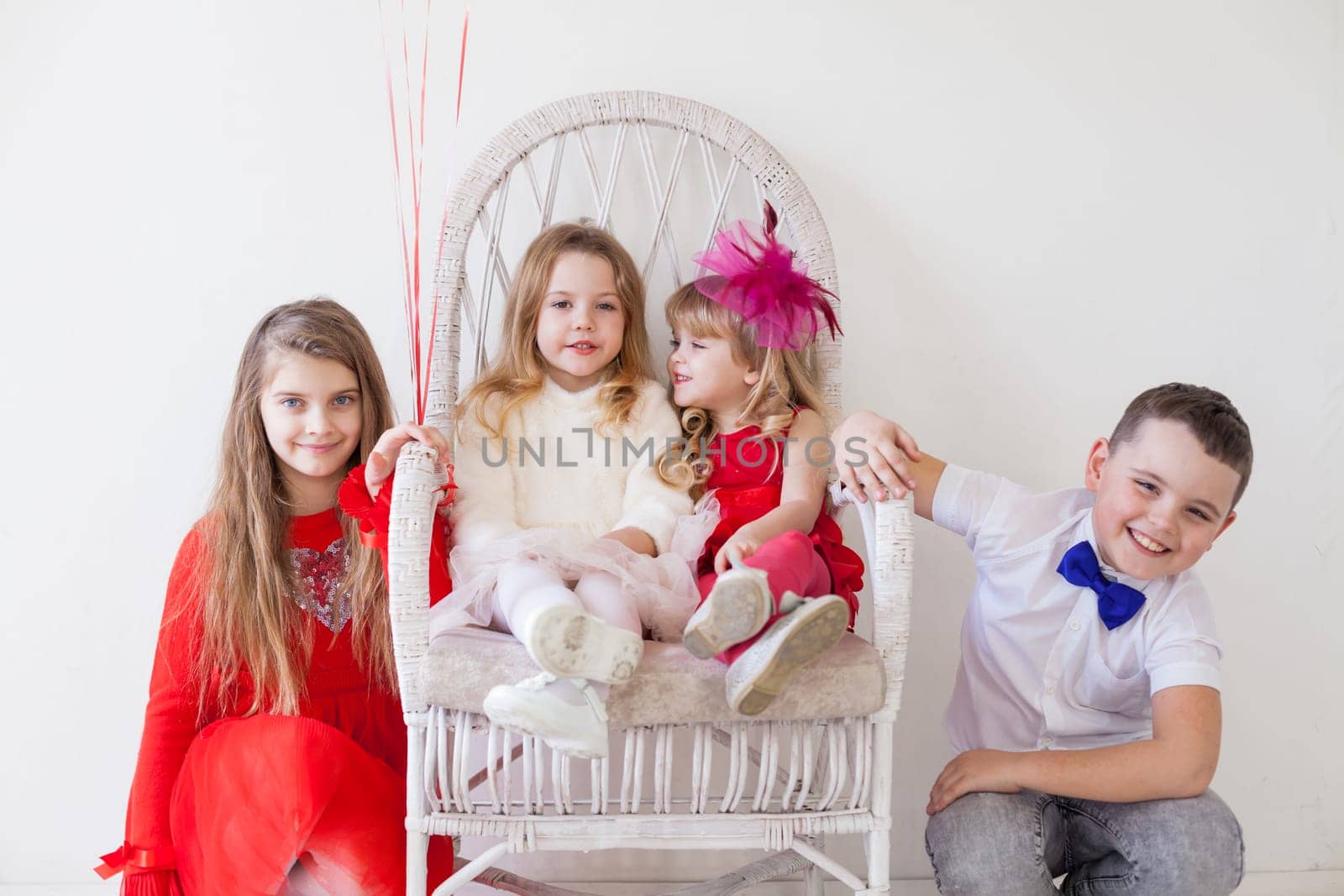 Kids are beautiful girls and the boy are sitting together by Simakov