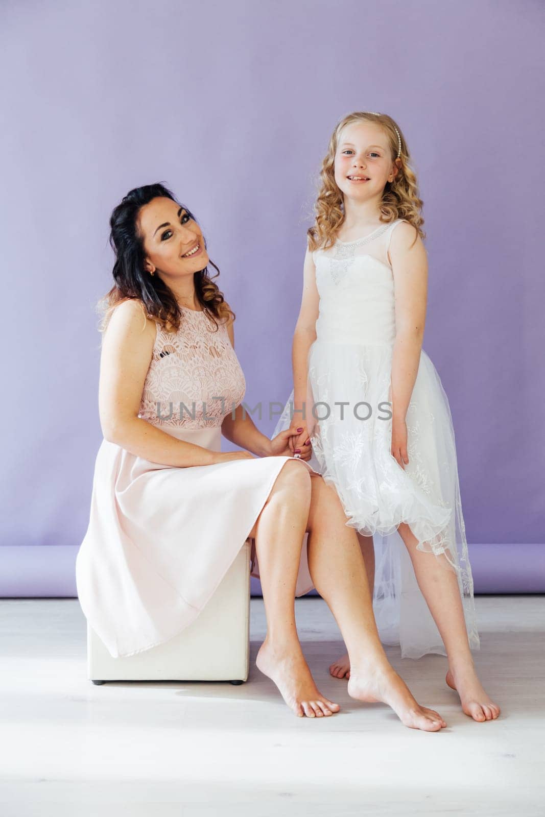 Mom and daughter portrait on a light background by Simakov