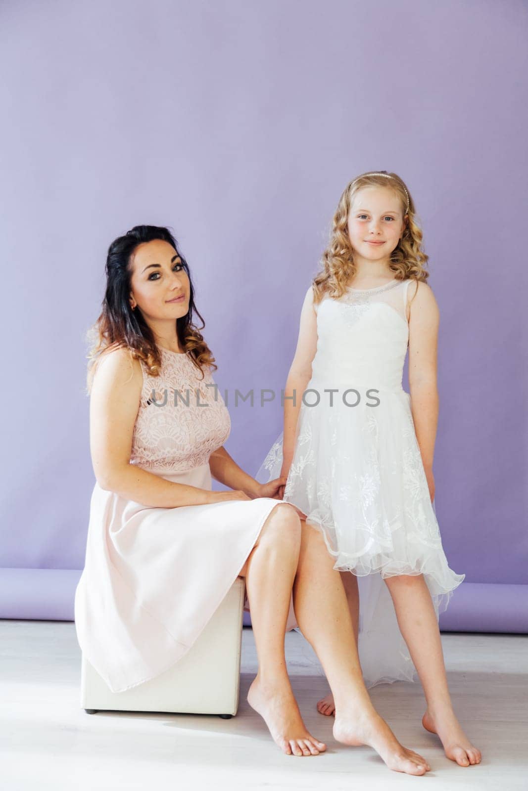 Mom and daughter portrait on a light background by Simakov