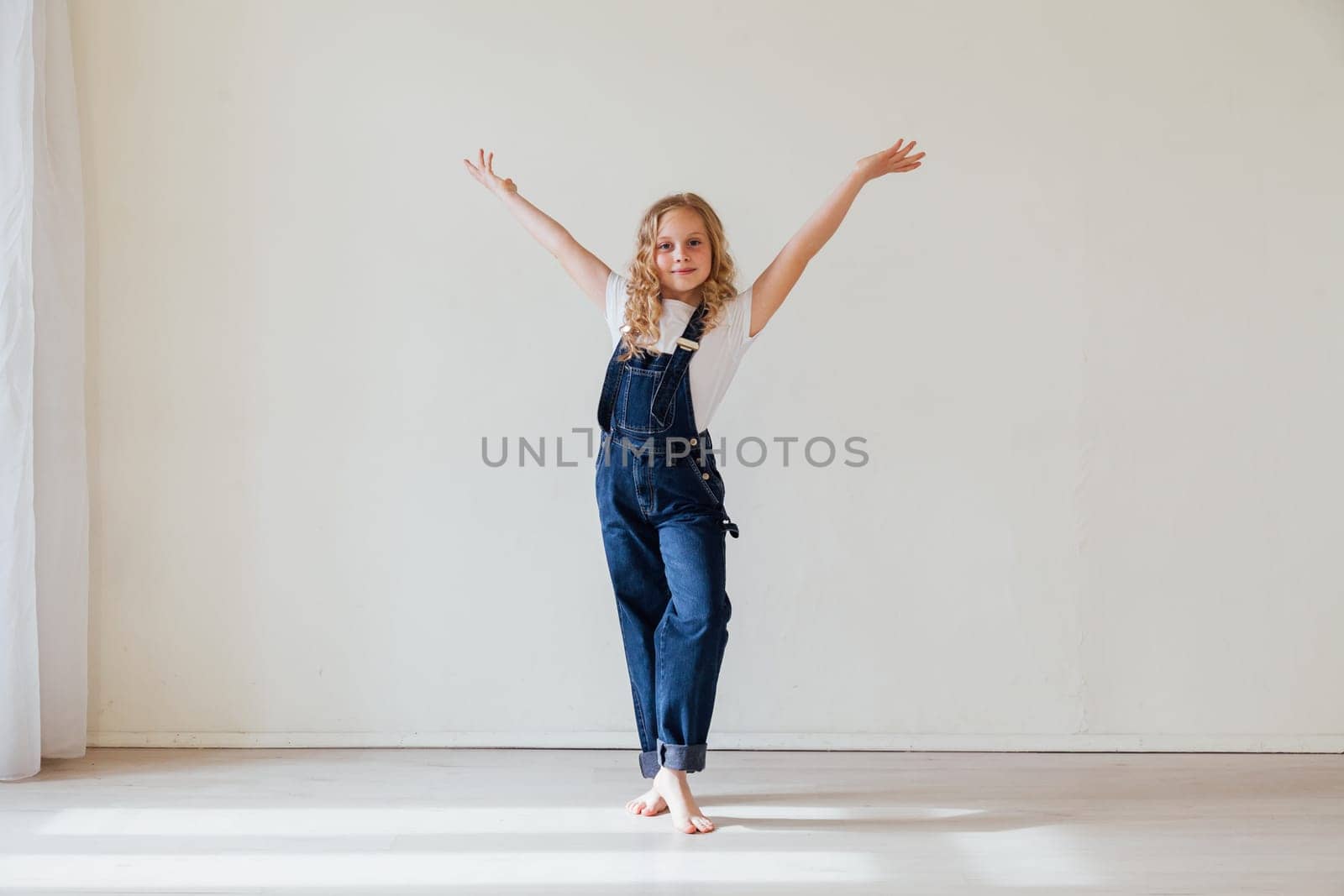 Beautiful blonde girl in denim jumpsuit portrait by Simakov
