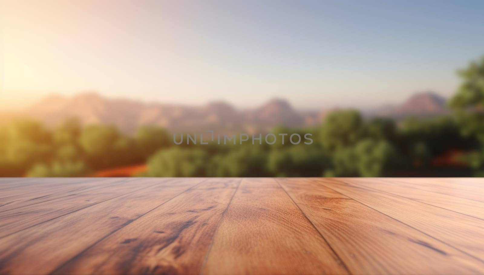 An empty wooden table top against the background of mountains, fields and the sky at sunset.