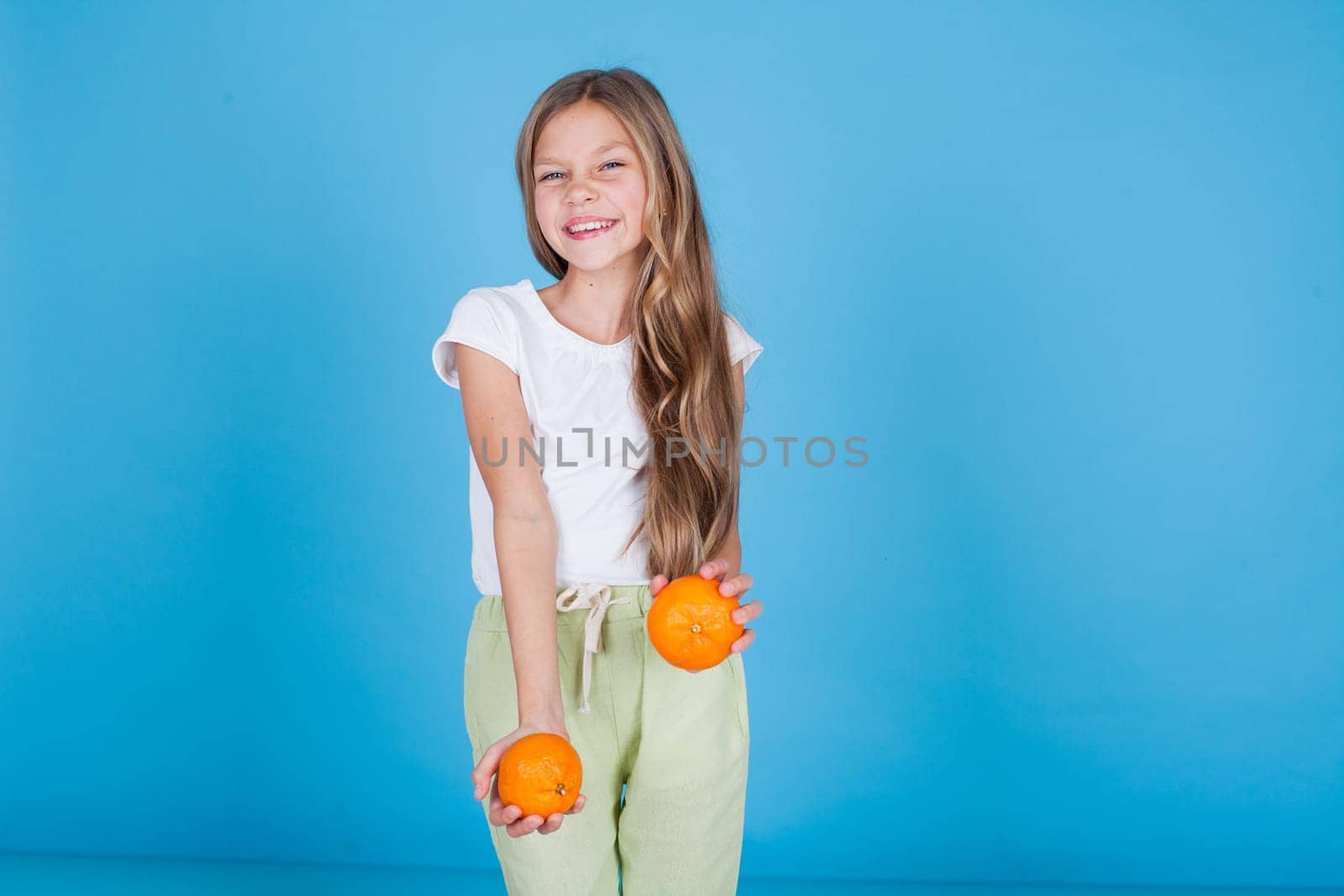 Beautiful girl holds ripe oranges fruit food by Simakov