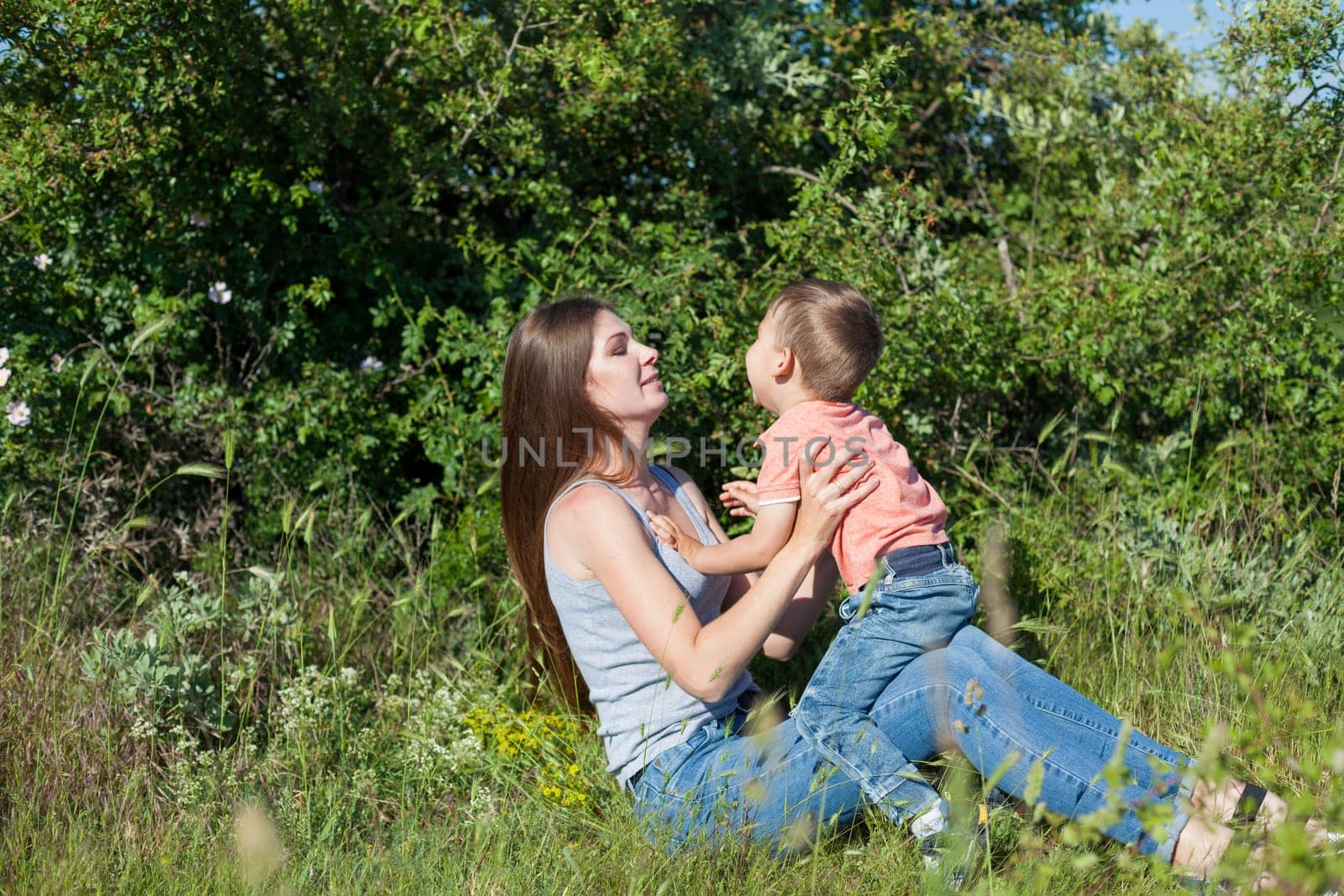 Mom and son play in the park on nature