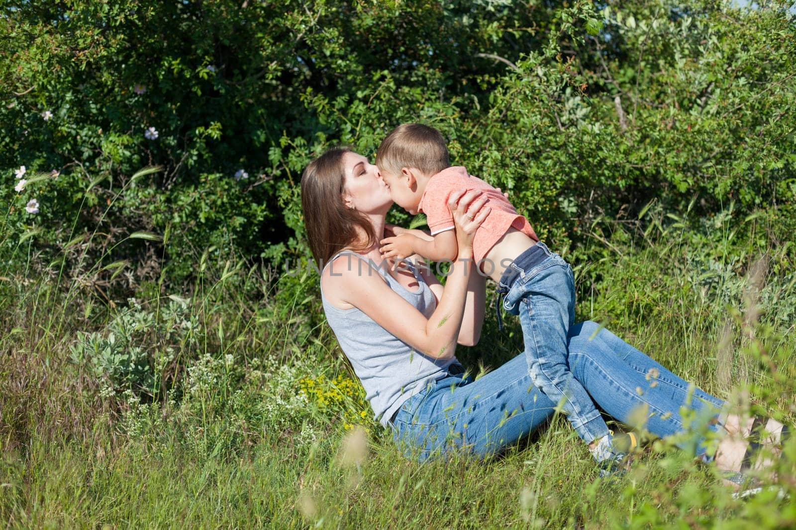 Mom and son play in the park on nature